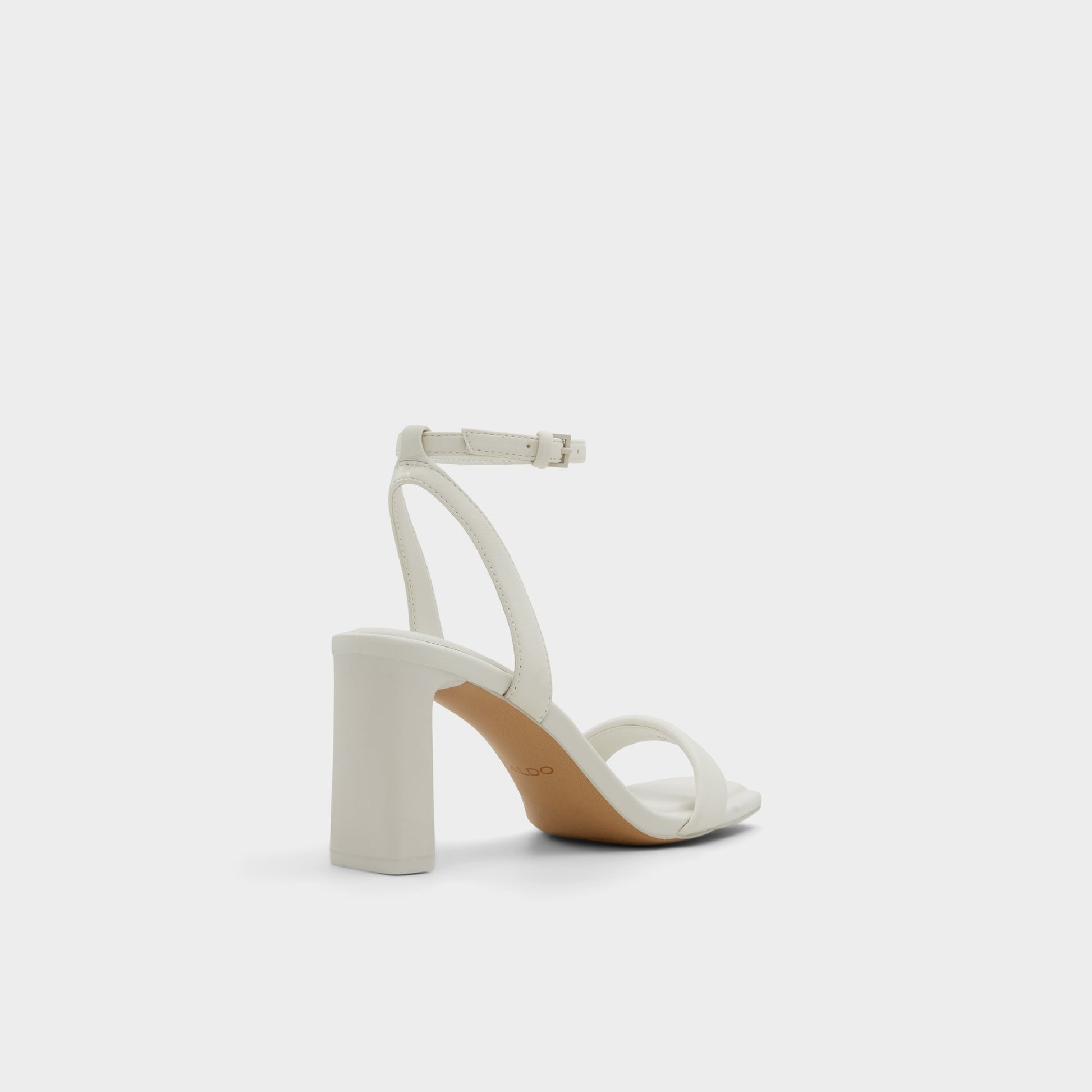 Three-quarter angle of White/Bone Aurorai Strappy heeled sandal's back side