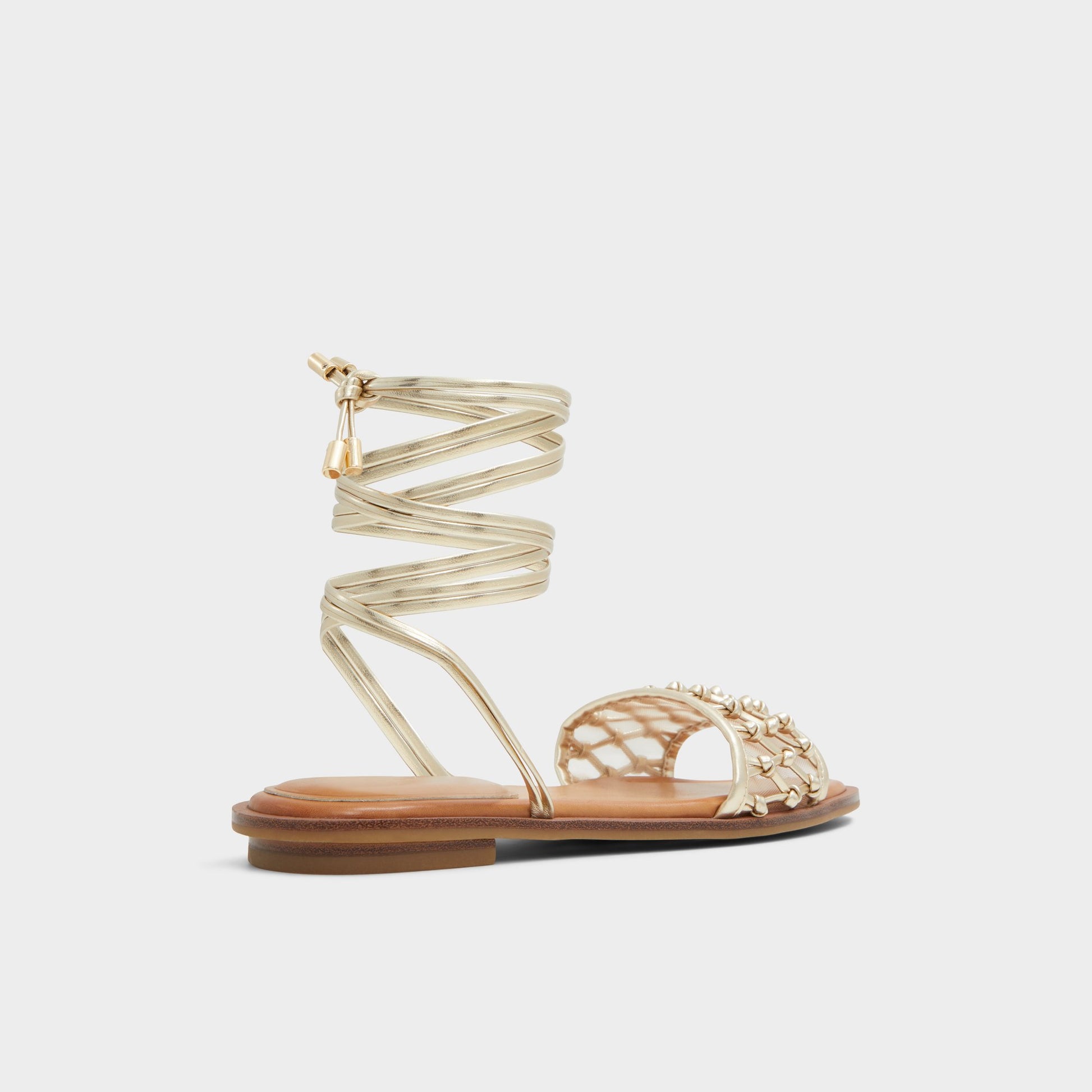 Three-quarter angle of Gold Seazen Flat sandal's back side