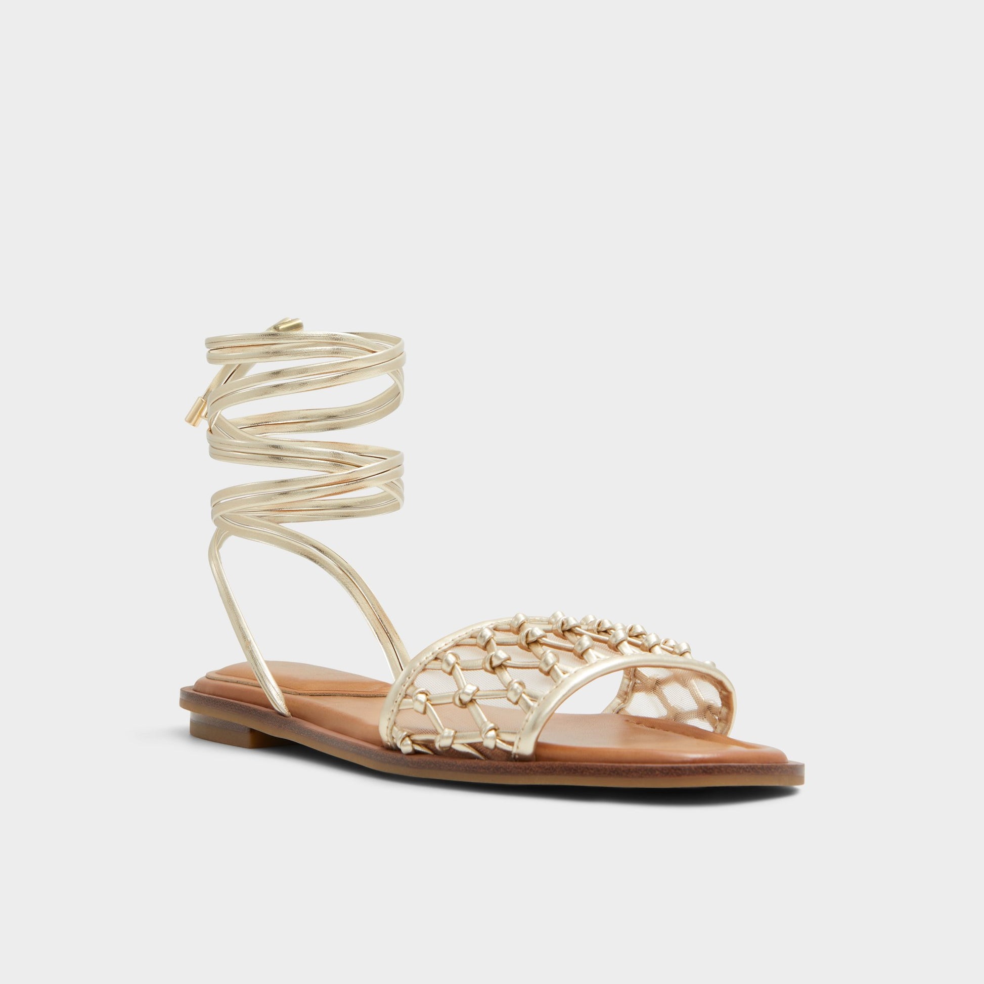 Three-quarter angle of Gold Seazen Flat sandal's front side