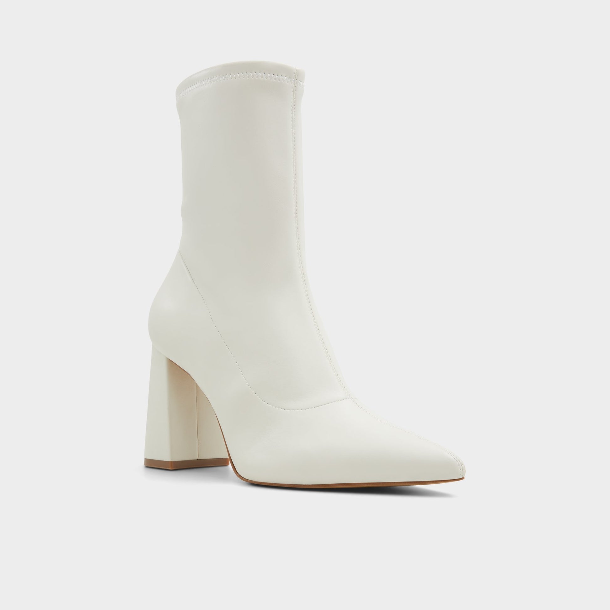 Three-quarter angle of White/Bone Figtree Ankle boot's front side