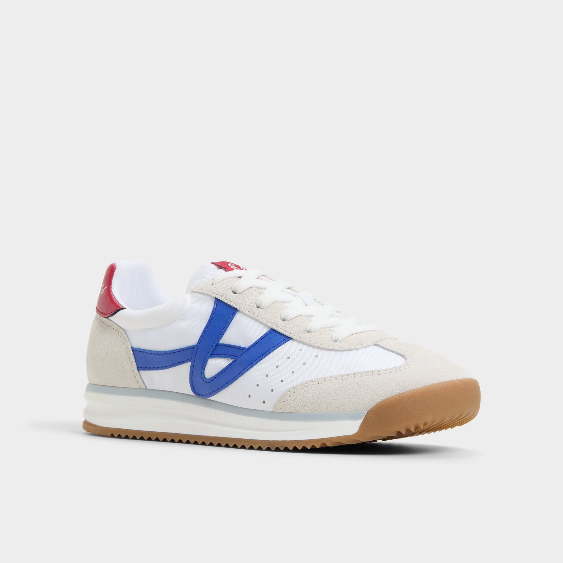 Three-quarter angle of White/Blue Stepcount Jogger sneaker's front side