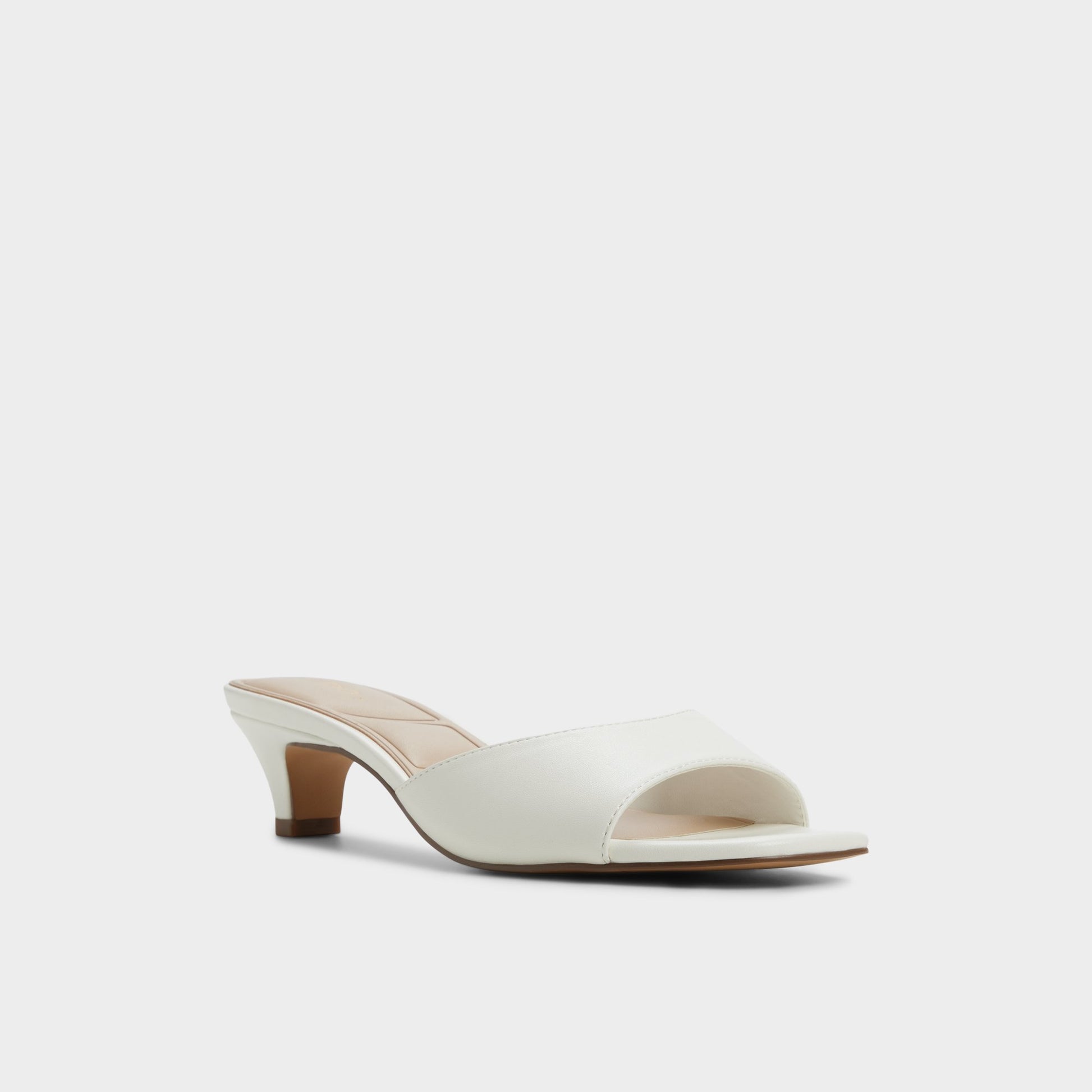 Three-quarter angle of White Haeden Heeled mule's front side