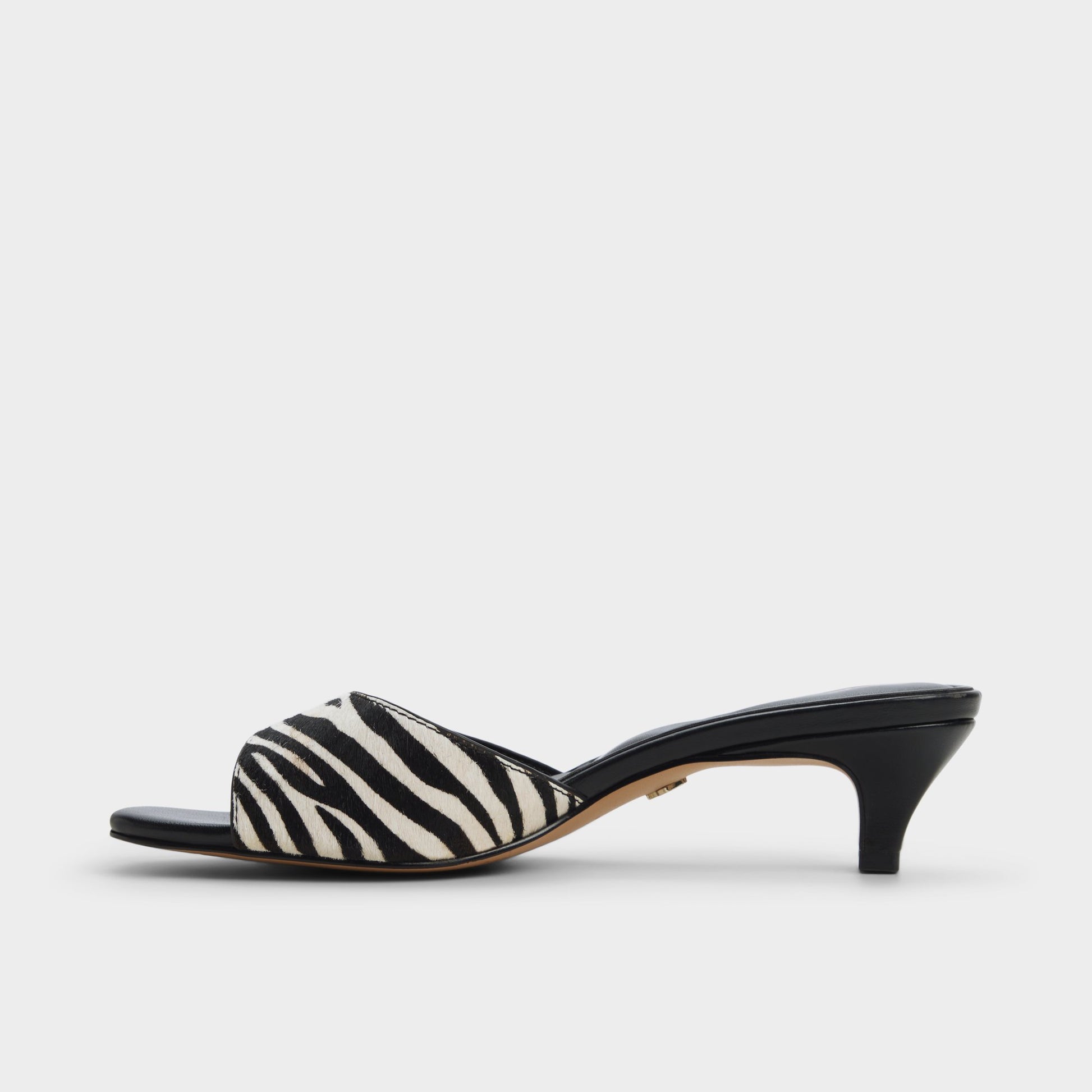 Side view of White/Black Haeden Heeled mule