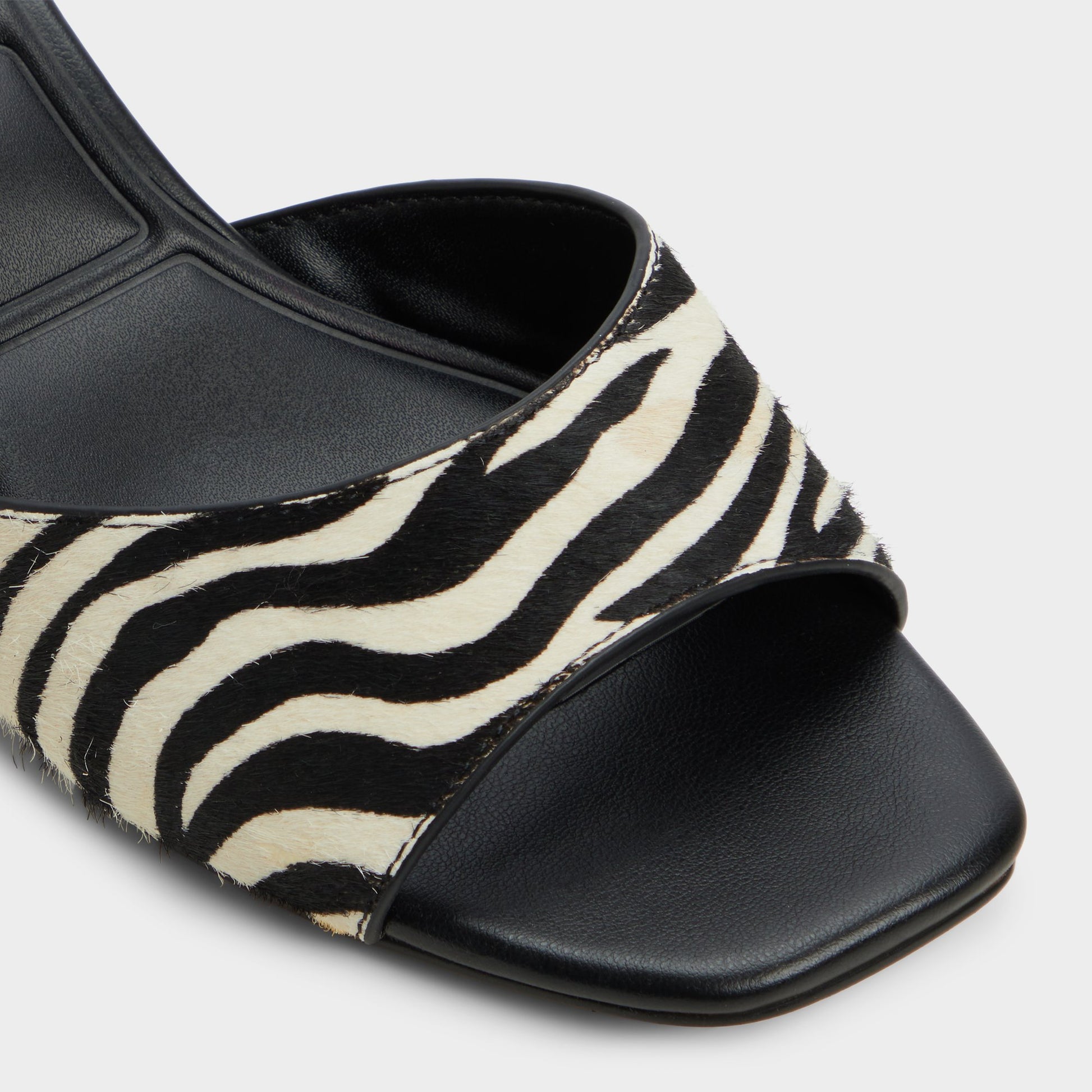 Close-up of the White/Black Haeden Heeled mule