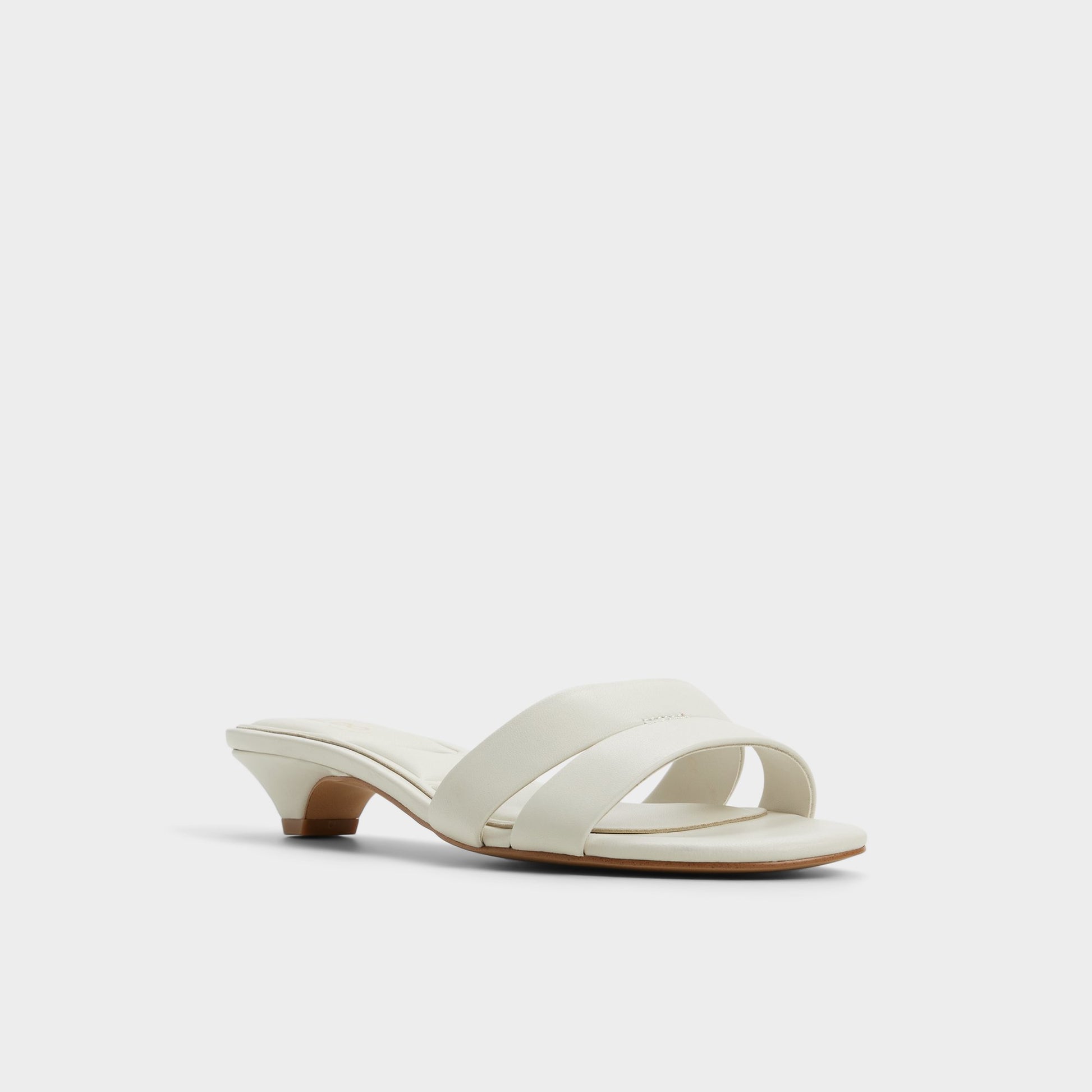 Three-quarter angle of White/Bone Scarletta Heeled mule's front side