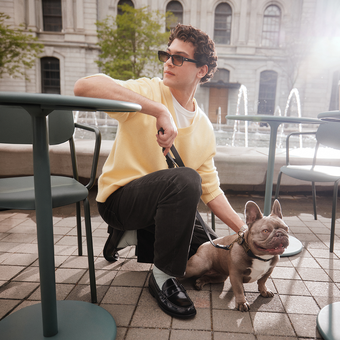 Man with his dog wearing black leather loafers