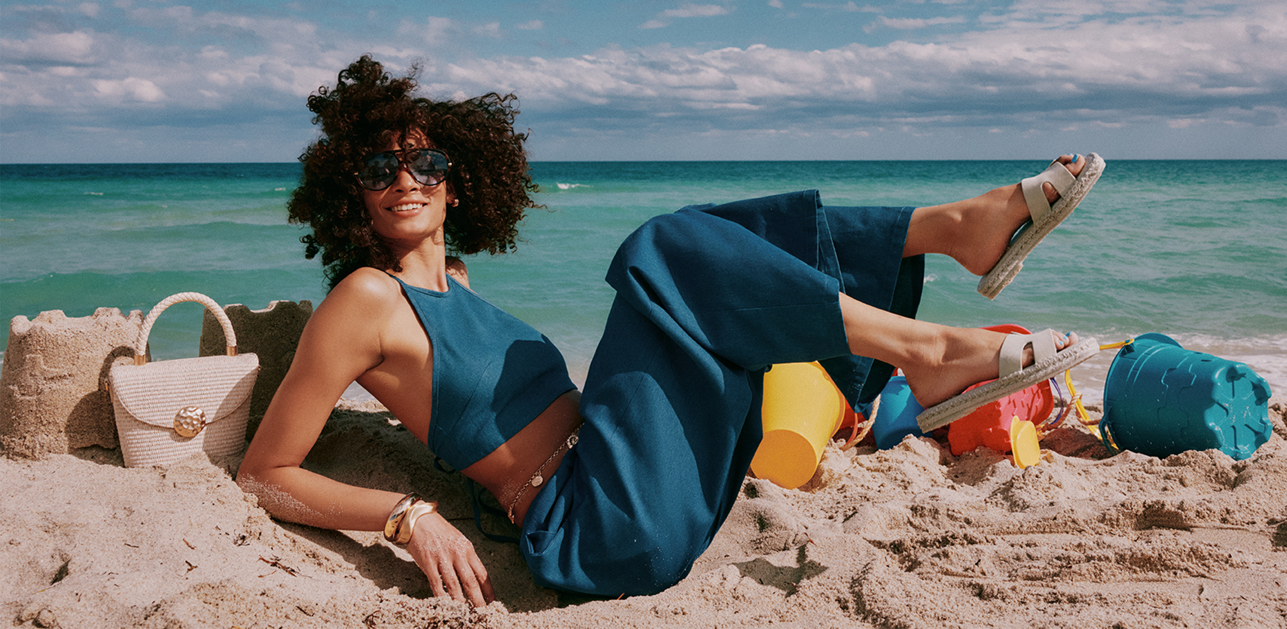 women on beach with sandals
