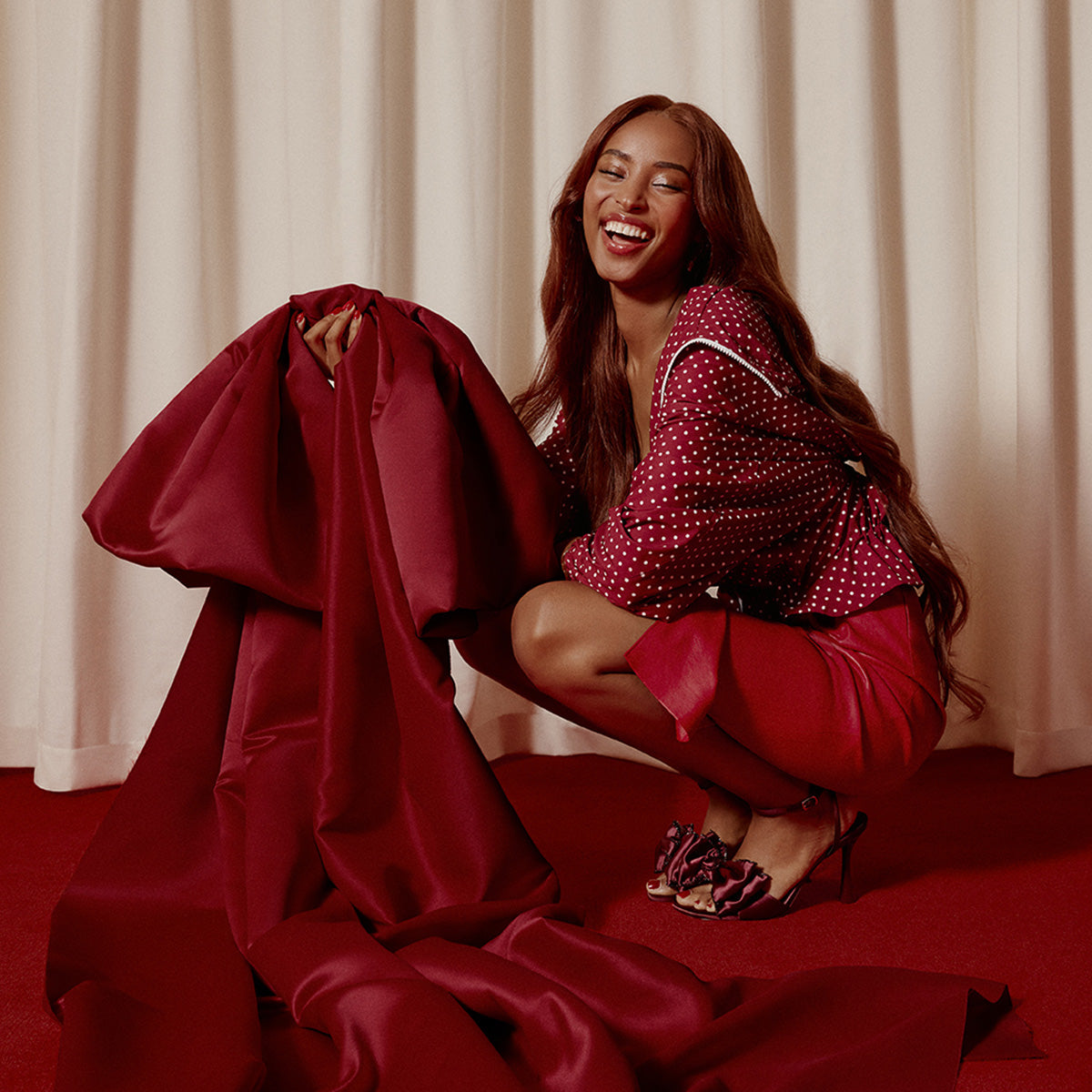 Woman in colorful outfit holding a brown handbag