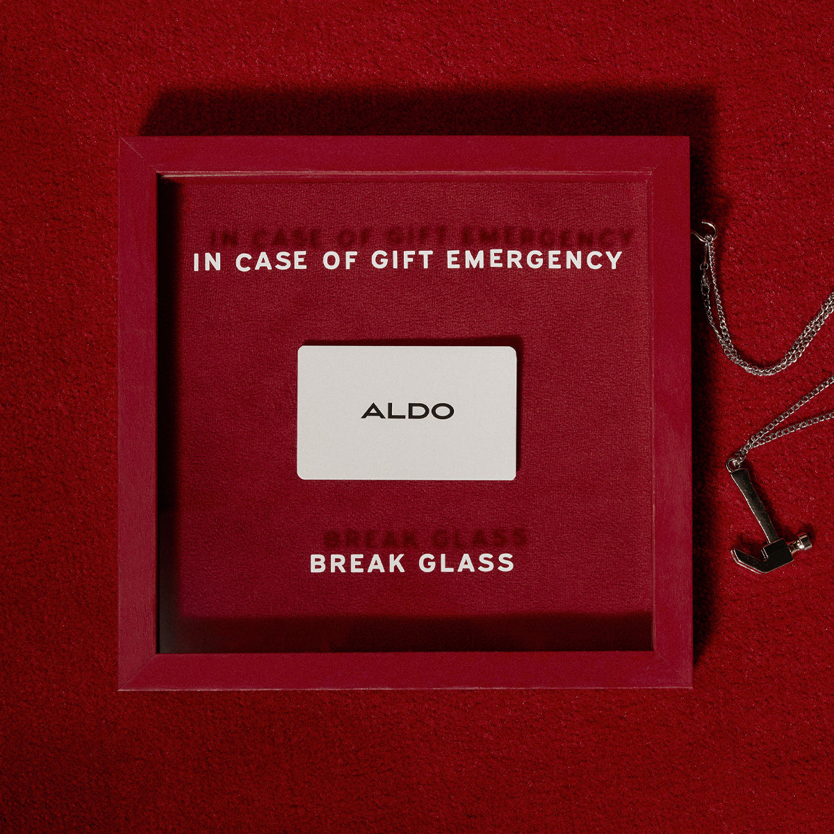 Red box with 'In case of gift emergency, break glass' text and Aldo gift card on a red background
