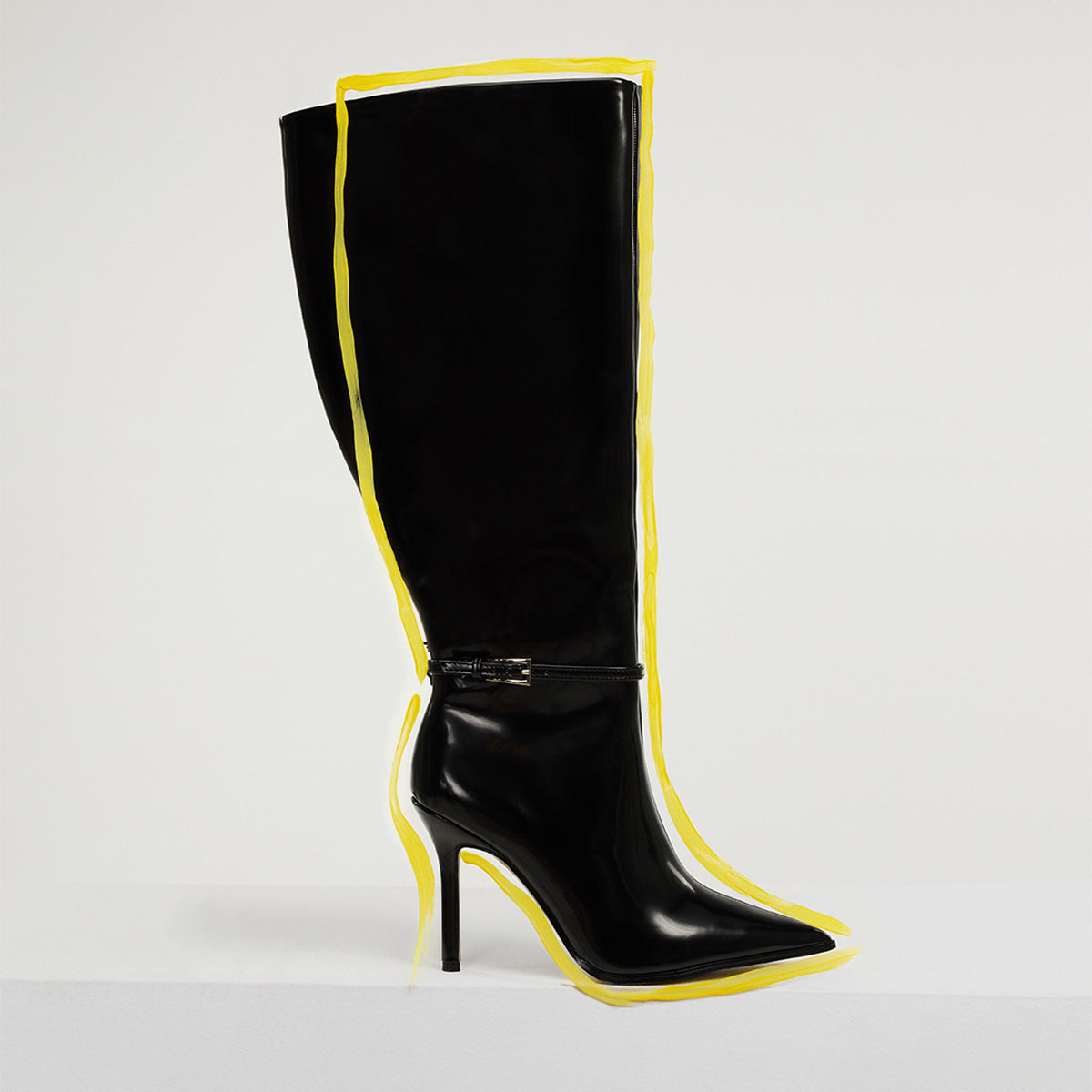 Black wide calf boot with a measuring tape on a snake skin patterned background