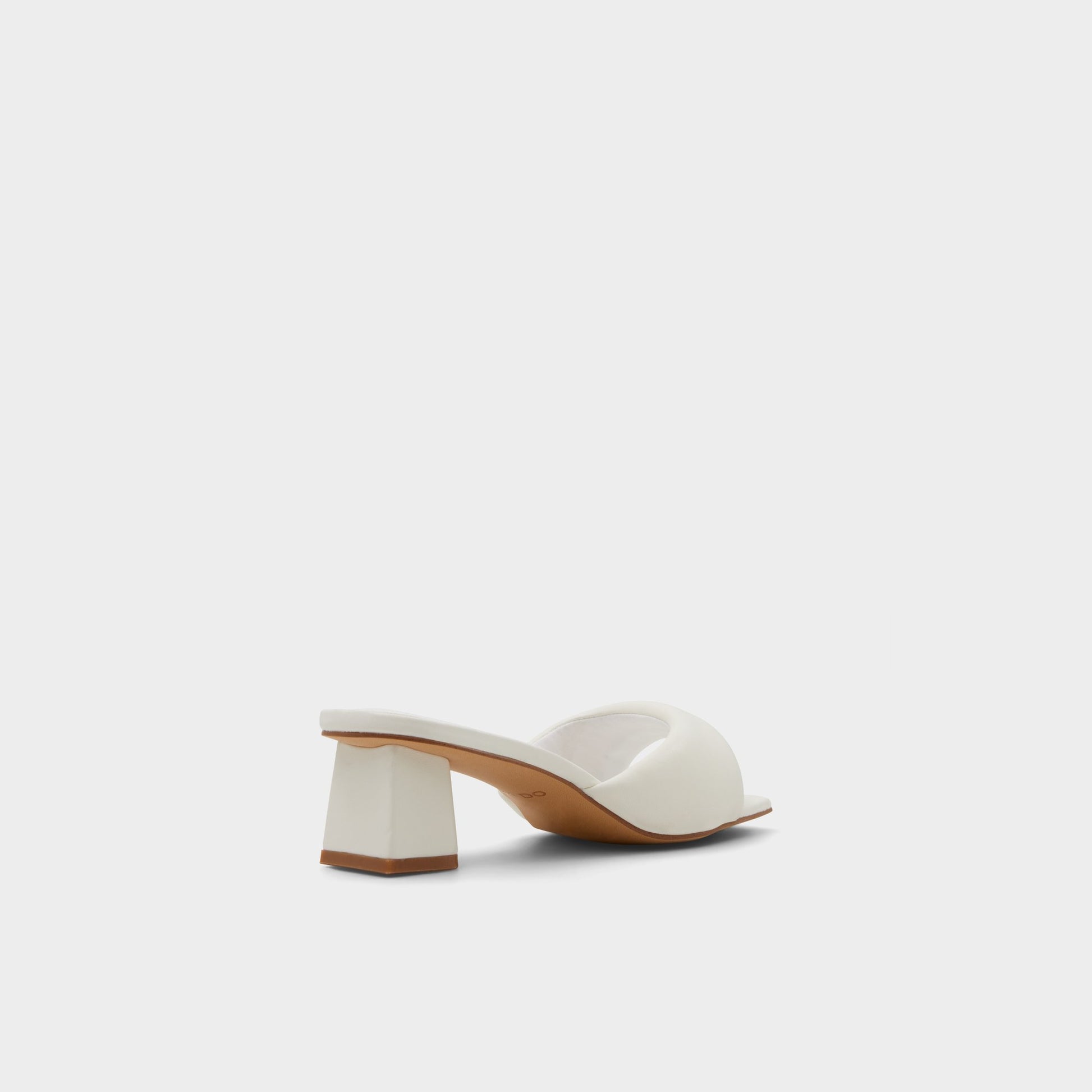 Three-quarter angle of White Aneka Heeled mule's back side