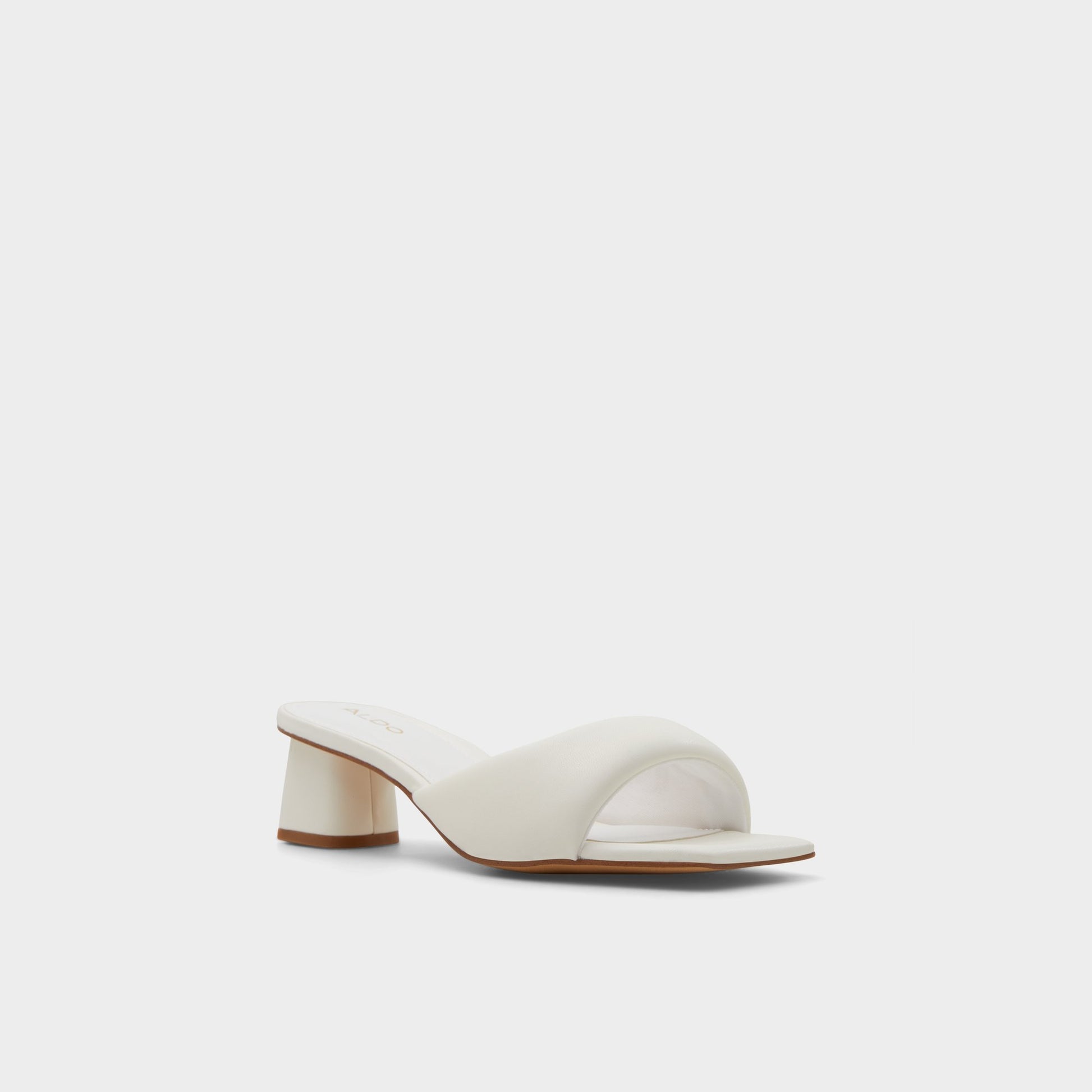 Three-quarter angle of White Aneka Heeled mule's front side