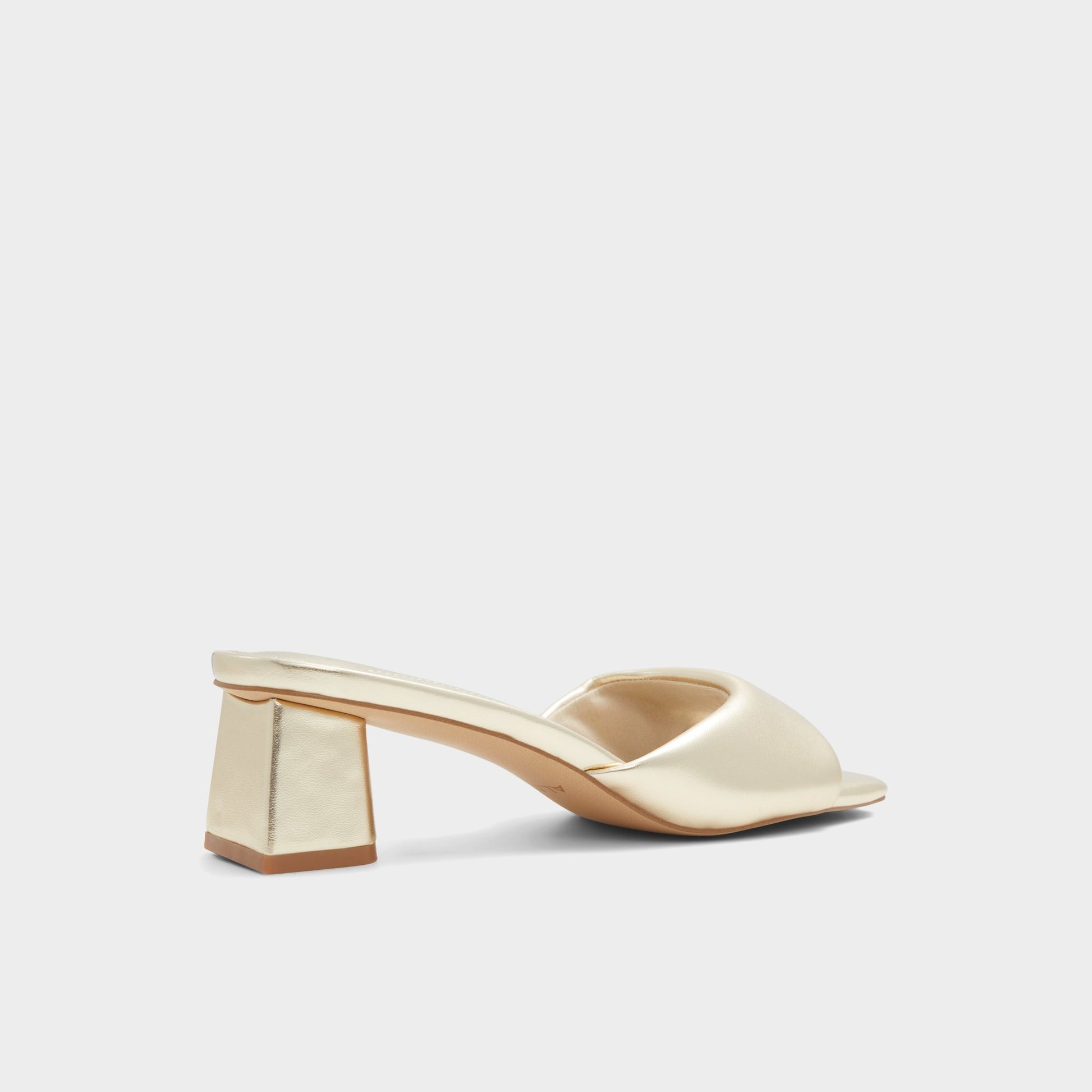 Three-quarter angle of Gold Aneka Heeled mule's back side