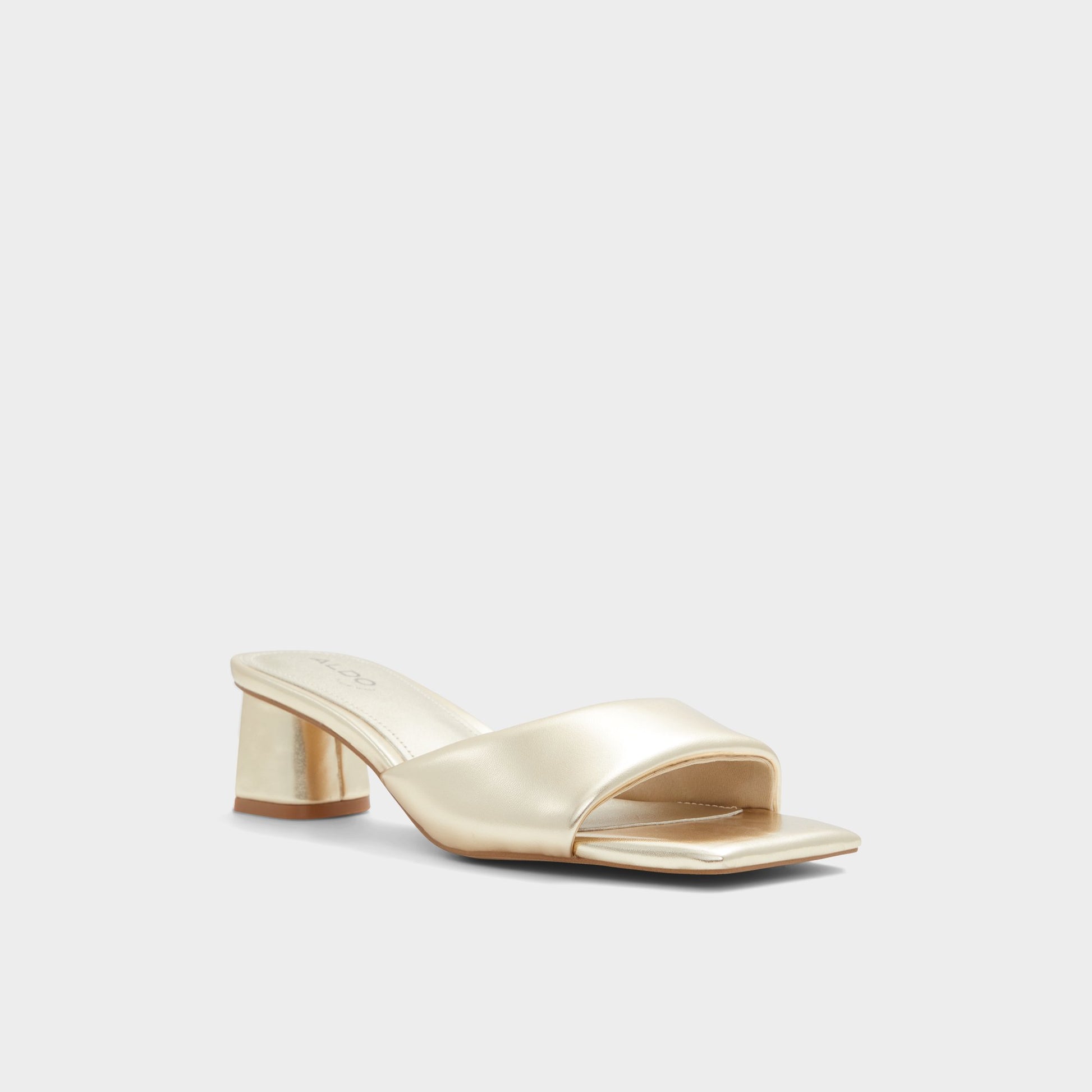 Three-quarter angle of Gold Aneka Heeled mule's front side