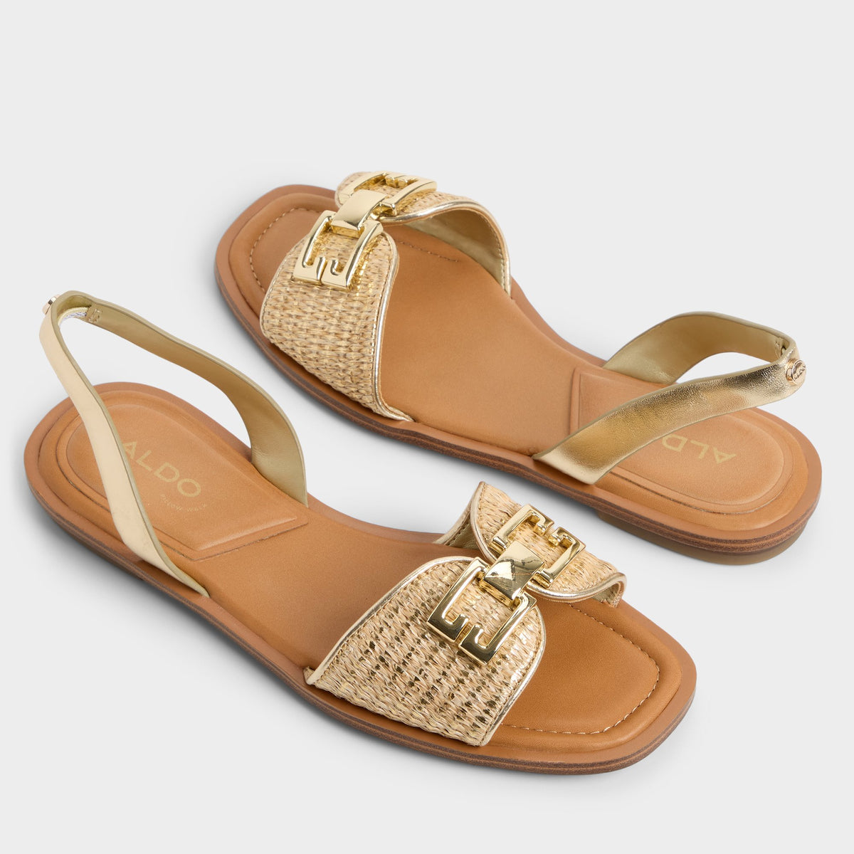 Highlighted view of a pair of Gold Agreinwan Flat sandals