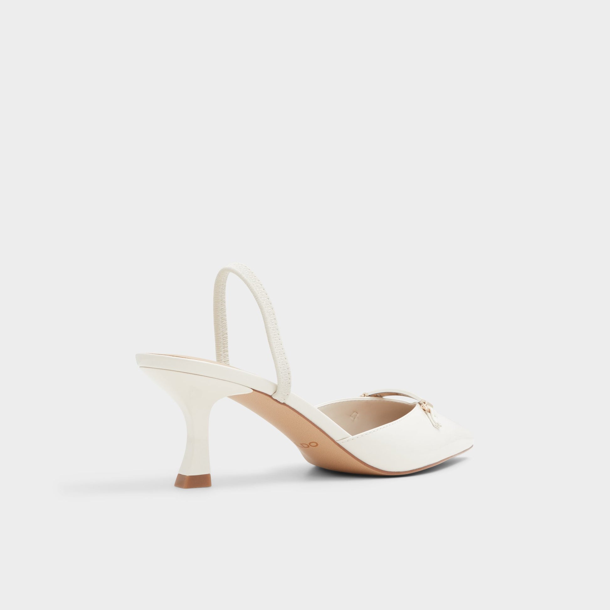 Three-quarter angle of White/Bone Nailah Slingback heel's back side