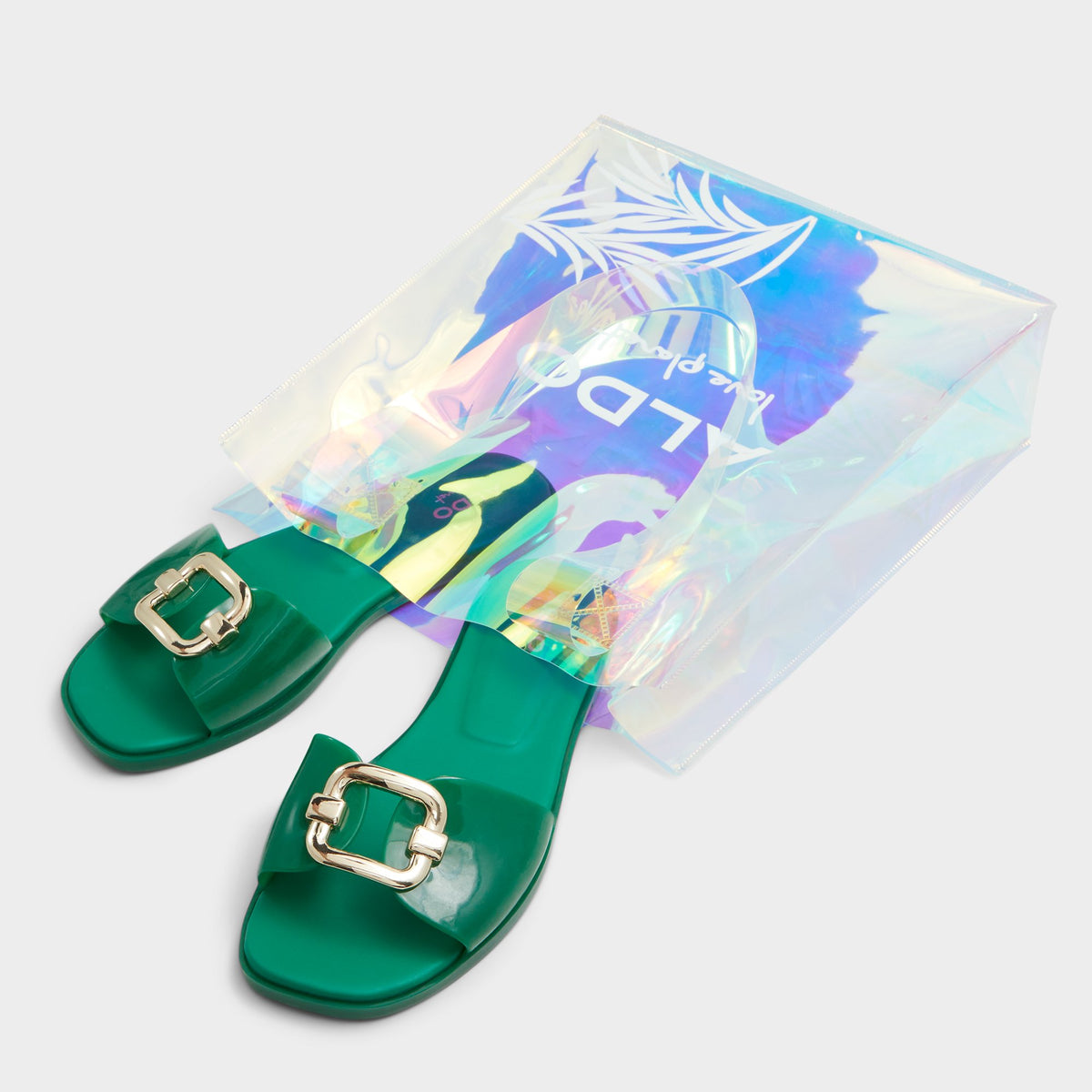 Highlighted view of a pair of Medium green Jellyicious Slide sandal &amp; tote bags