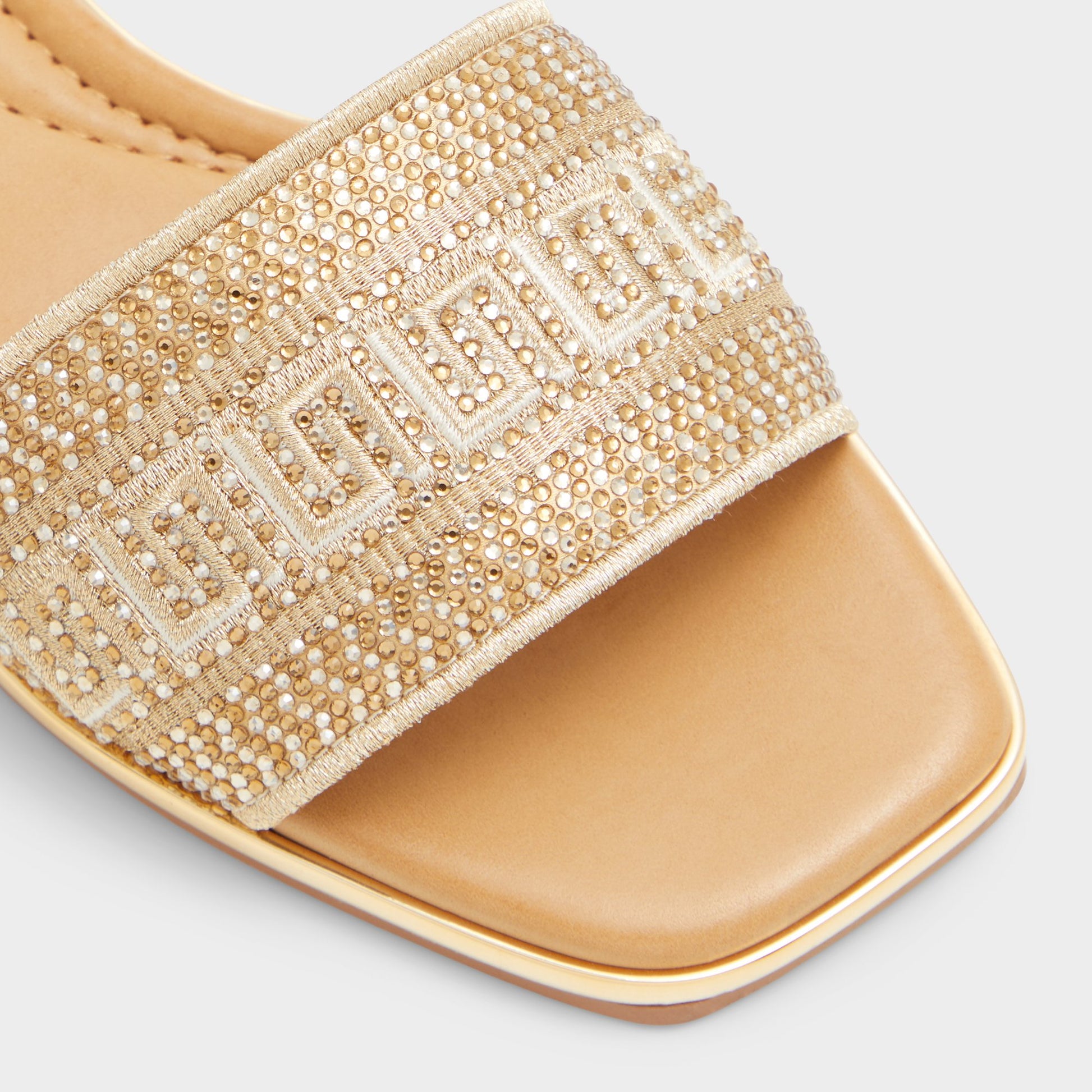 Close-up of the Gold Oceania Slide sandal