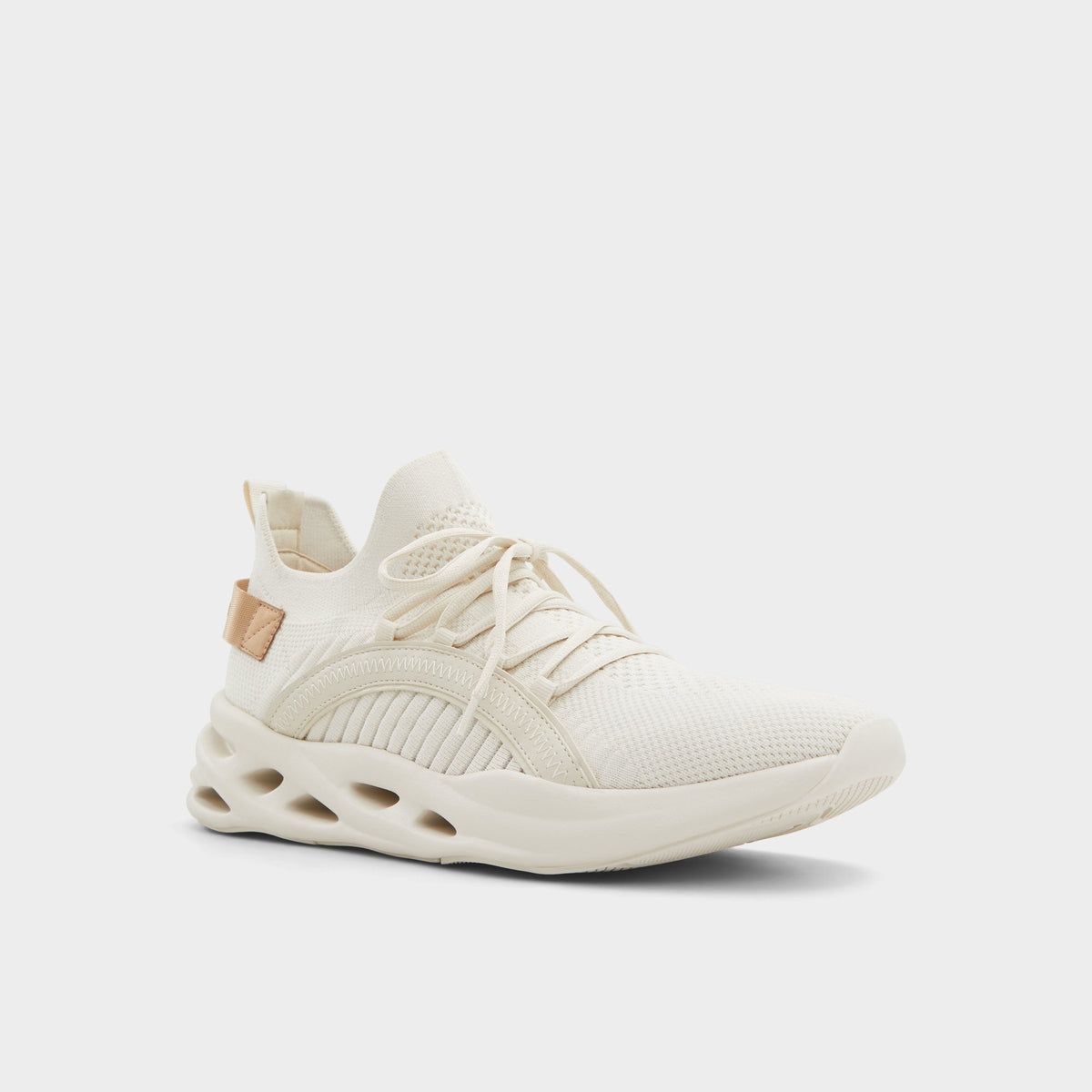 Three-quarter angle of White/Bone Motionx Jogger sneaker's front side