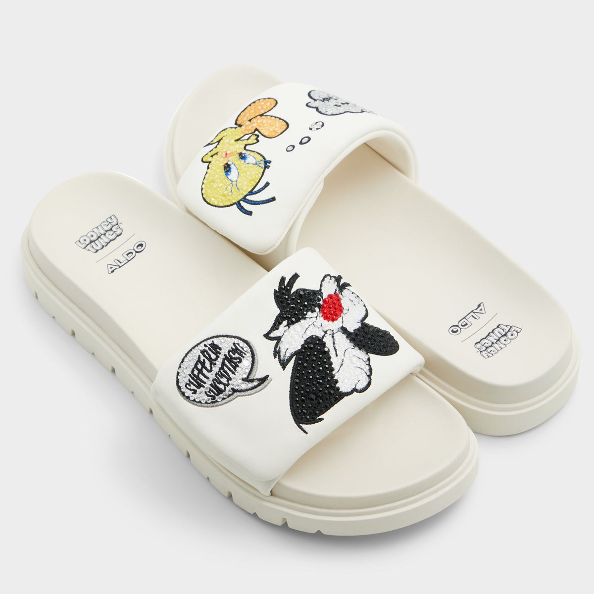 Highlighted view of a pair of White Ltslides Looney Tunesâ¢ x ALDOs