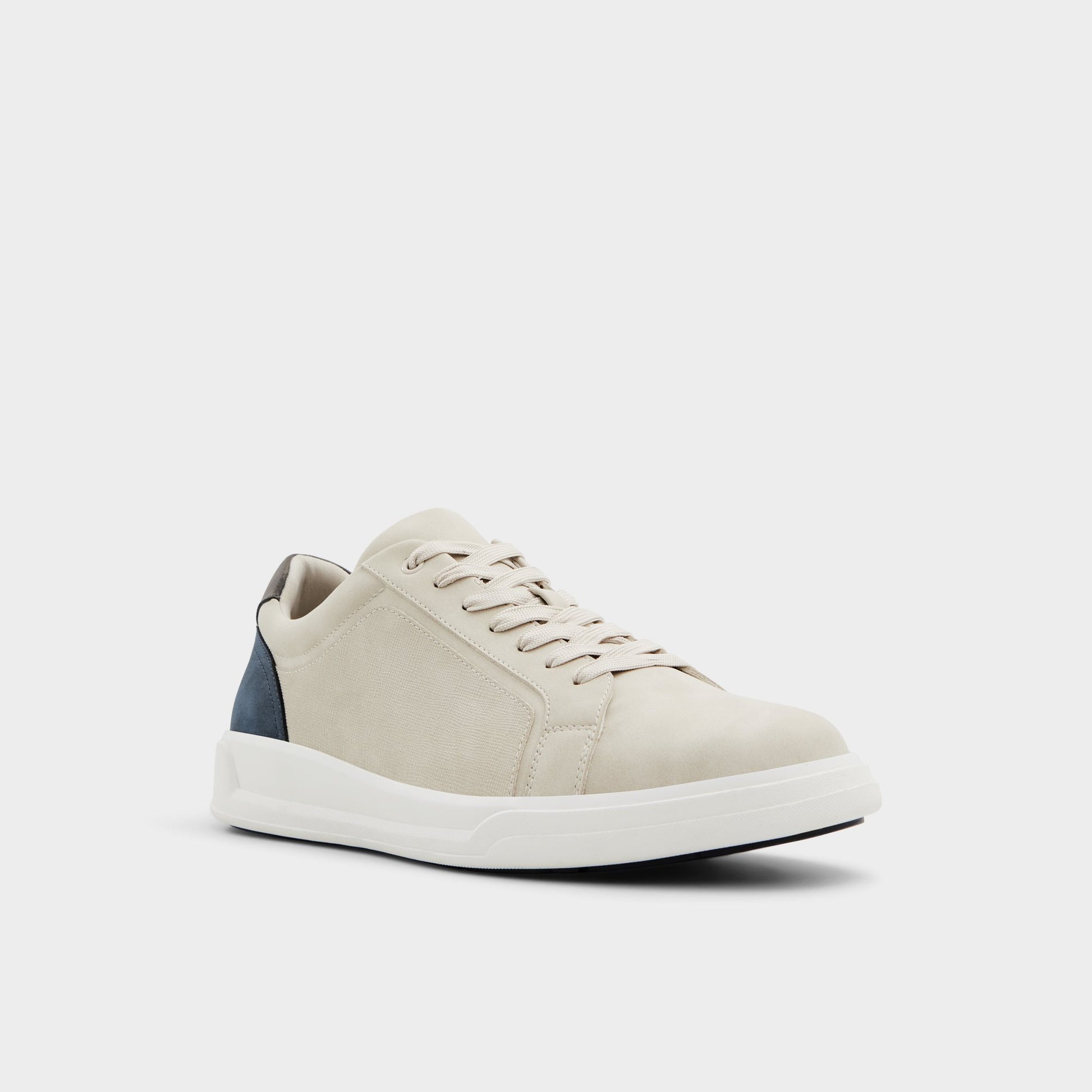 Three-quarter angle of Beige Ogspec Low top sneaker's front side