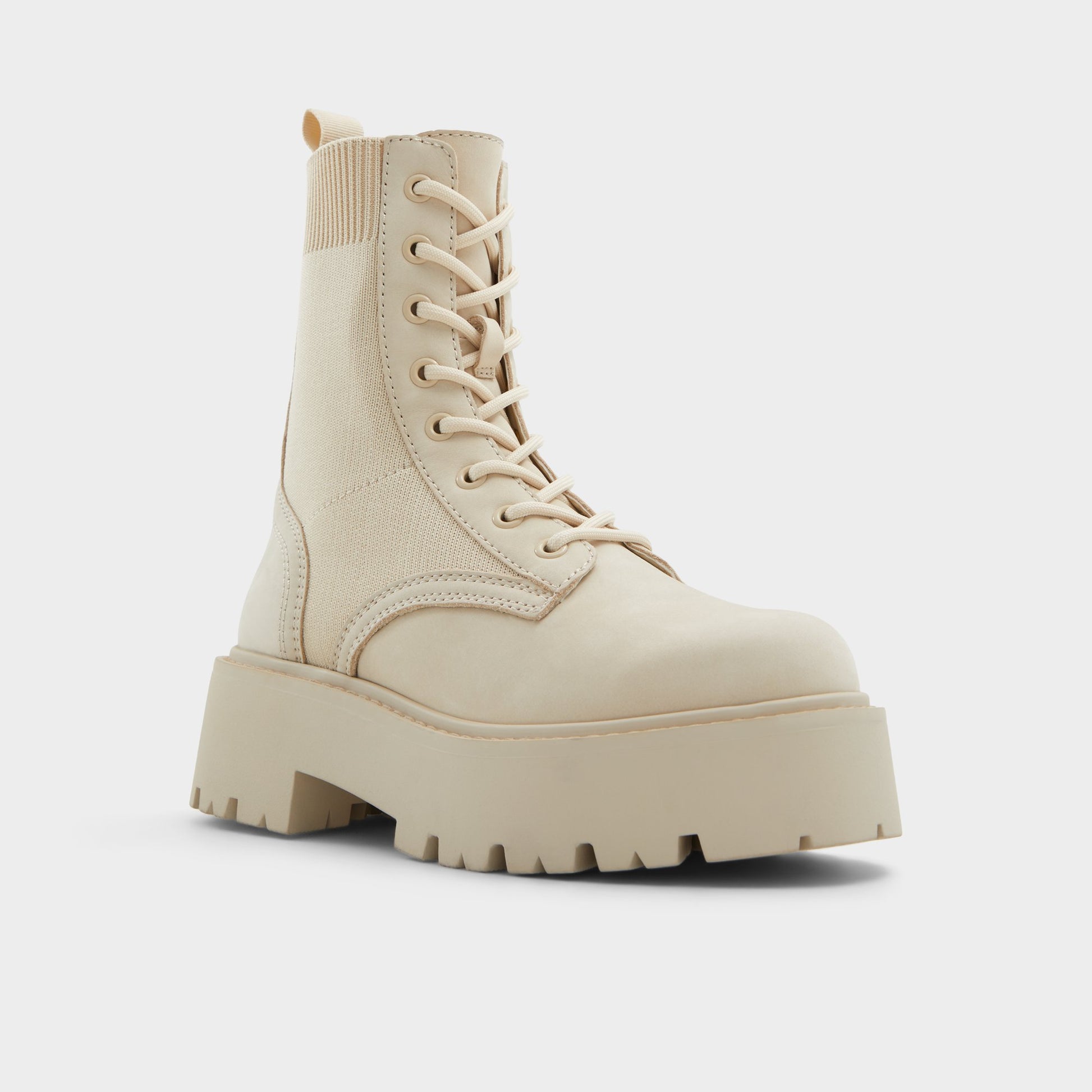 Three-quarter angle of Beige Talaleryknit Combat ankle boot's front side