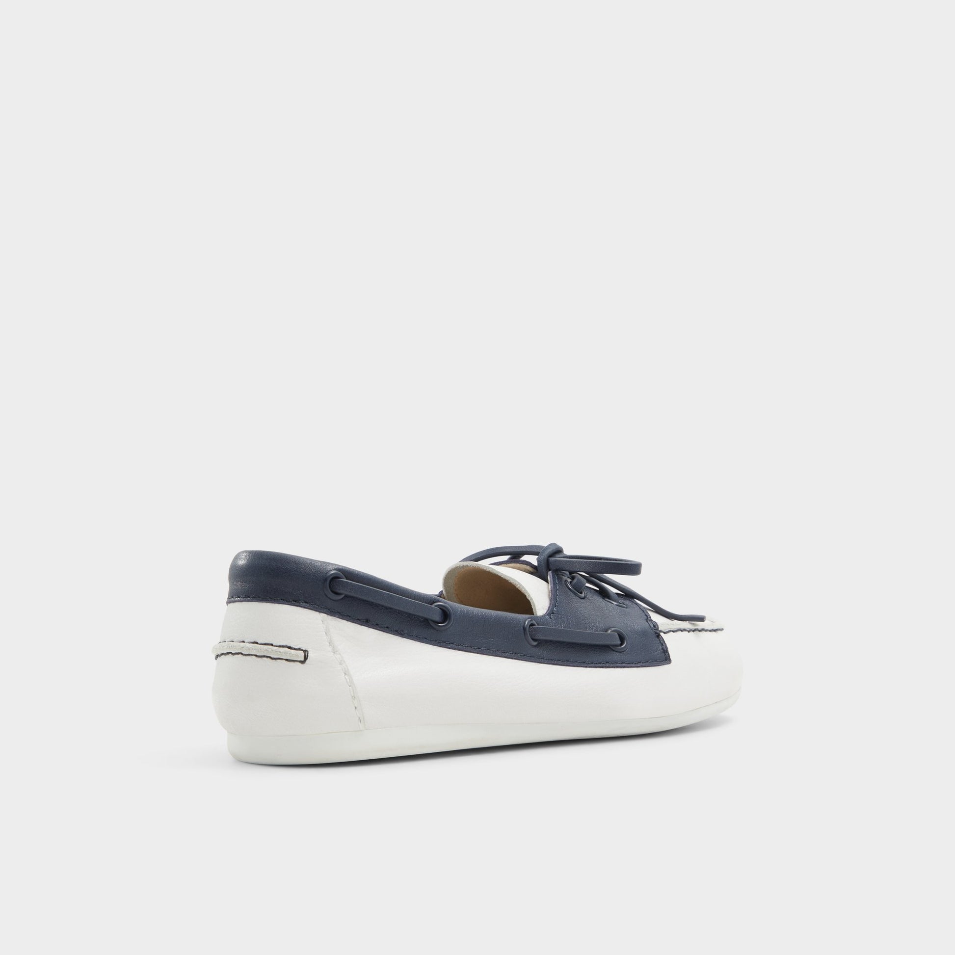 Three-quarter angle of White/Navy Sail Boat shoe's back side