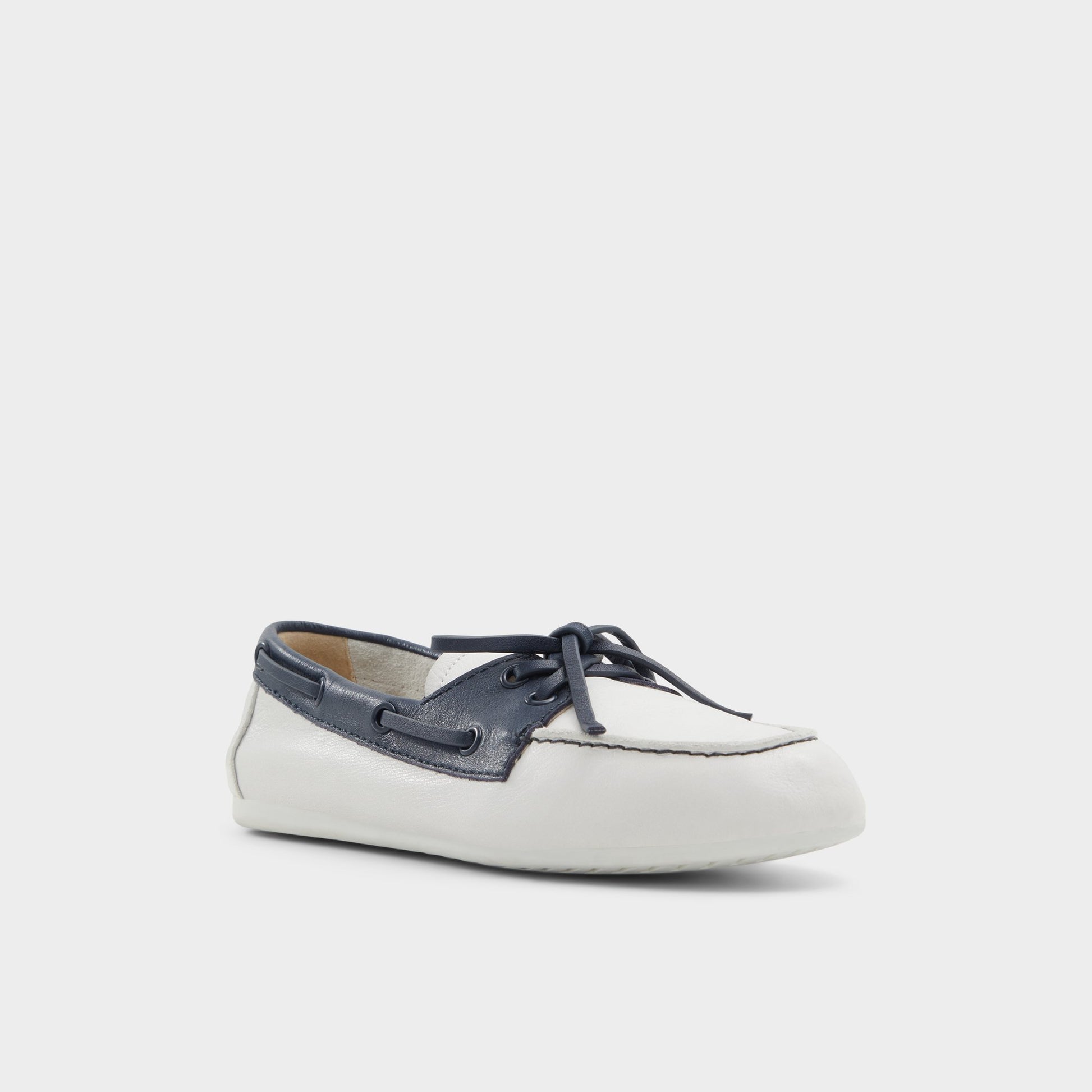 Three-quarter angle of White/Navy Sail Boat shoe's front side