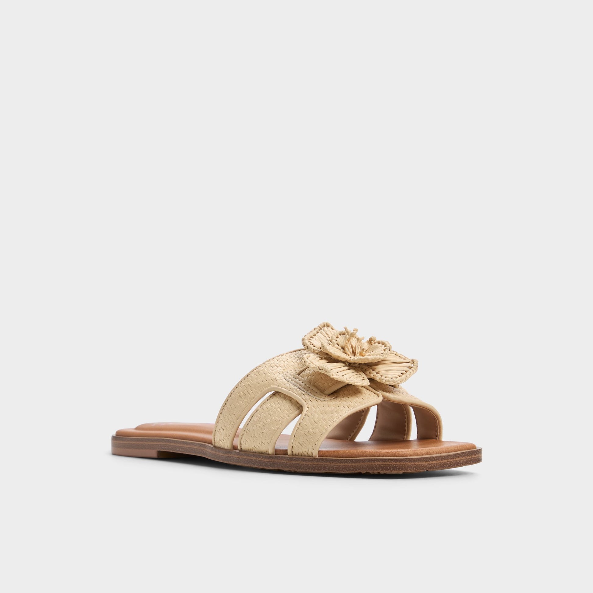 Three-quarter angle of Light Beige Seaflower Slide sandal's front side