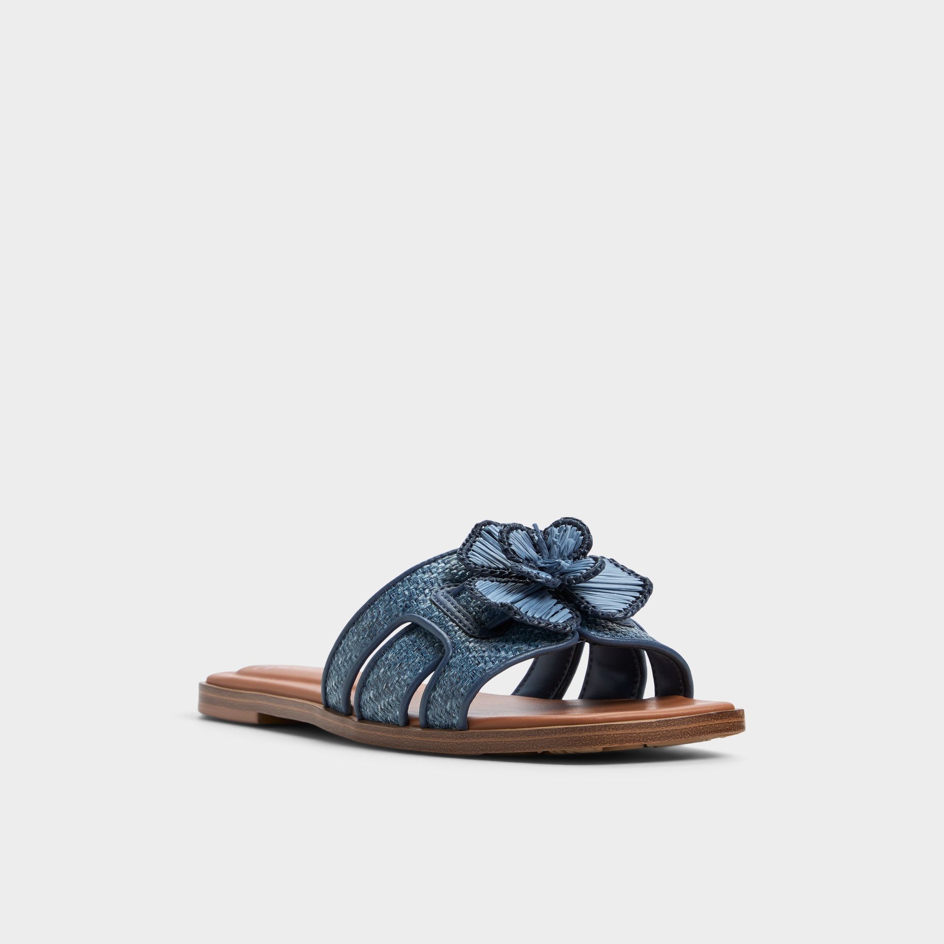 Three-quarter angle of Denim Seaflower Slide sandal's front side