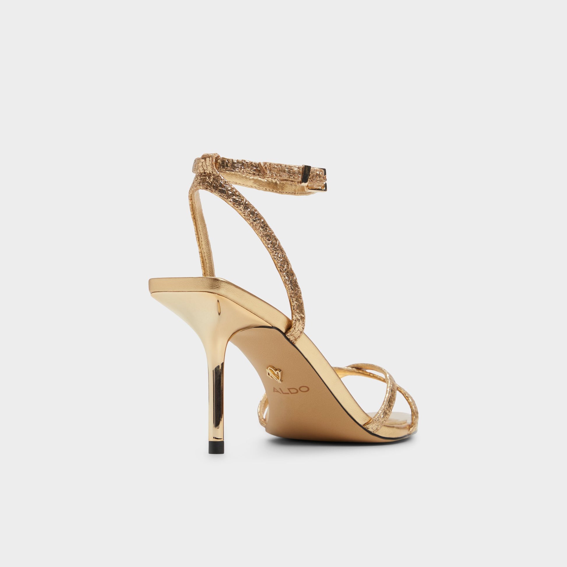 Three-quarter angle of Gold Adrina Strappy heeled sandal's back side