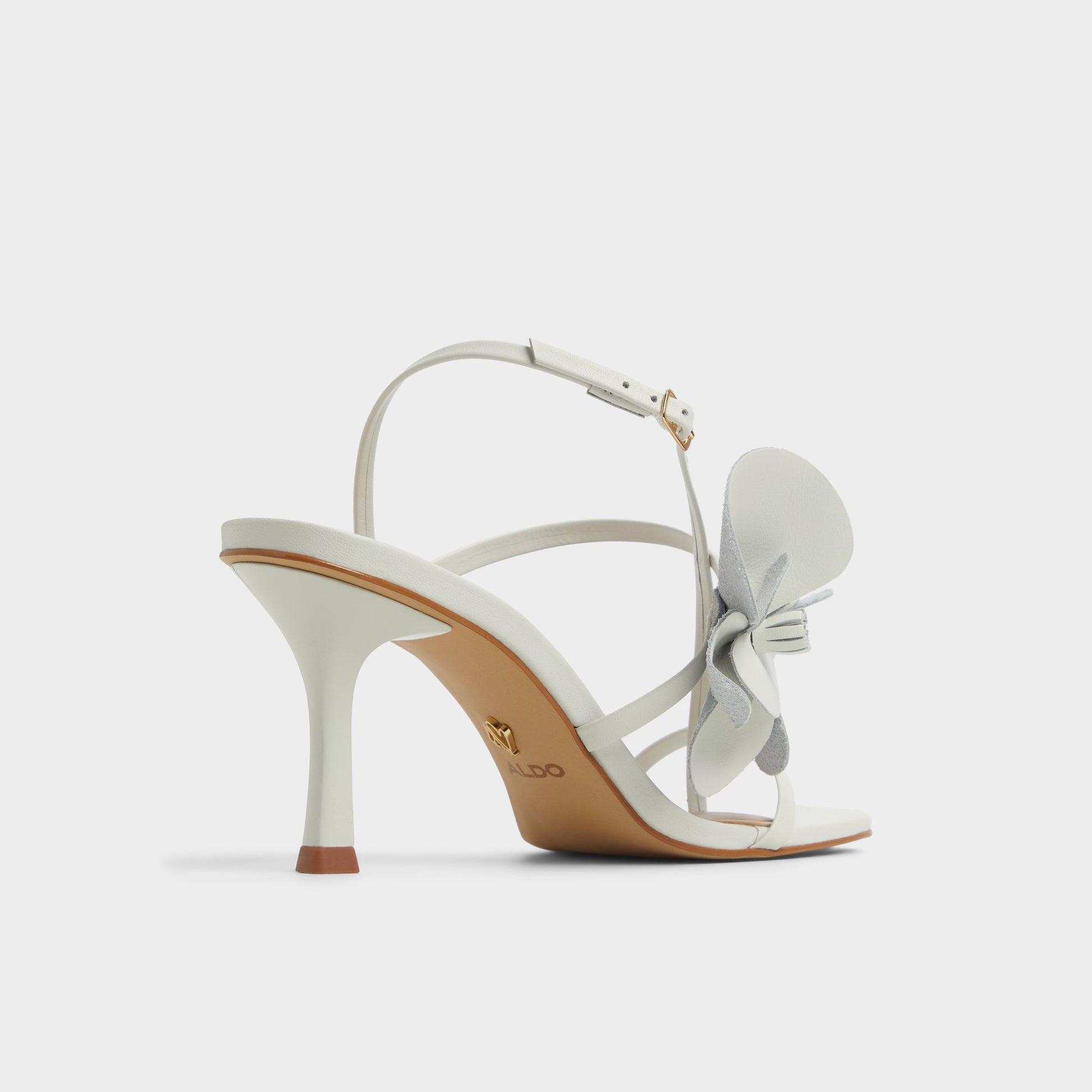 Three-quarter angle of White/Bone Sandflower Strappy heeled sandal's back side