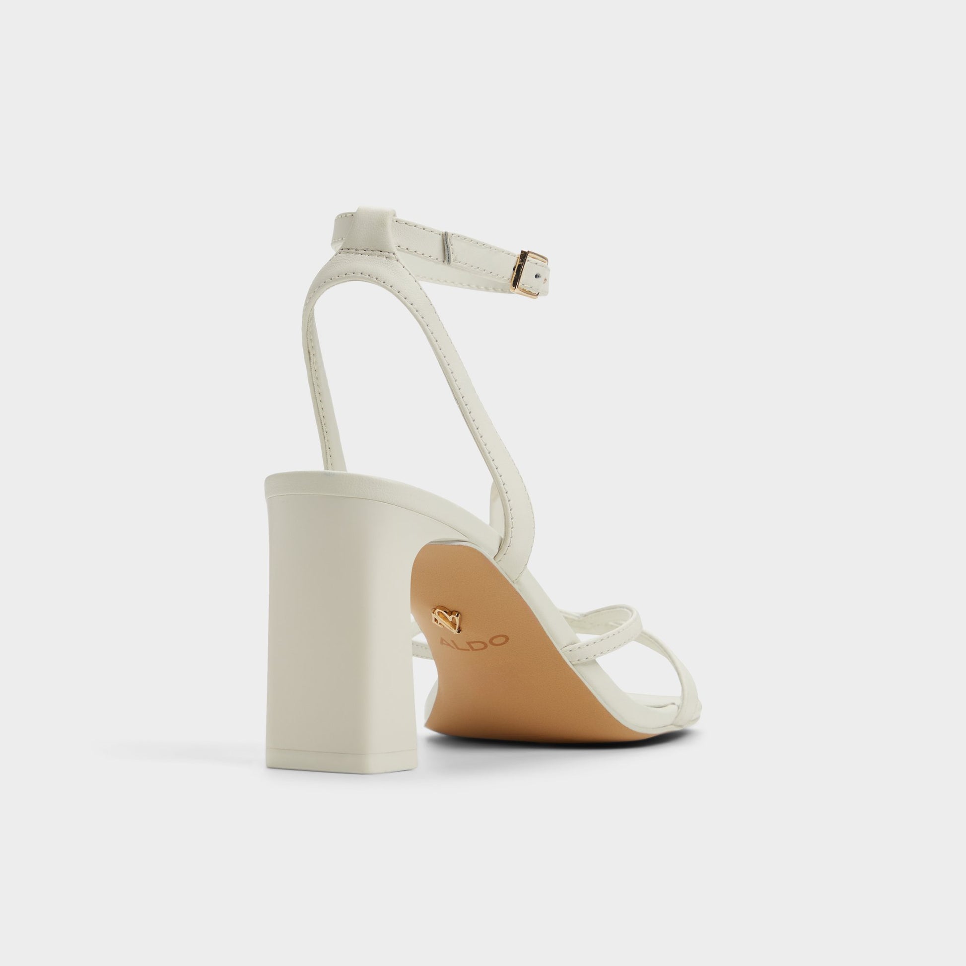 Three-quarter angle of White/Bone Stellare Strappy heeled sandal's back side