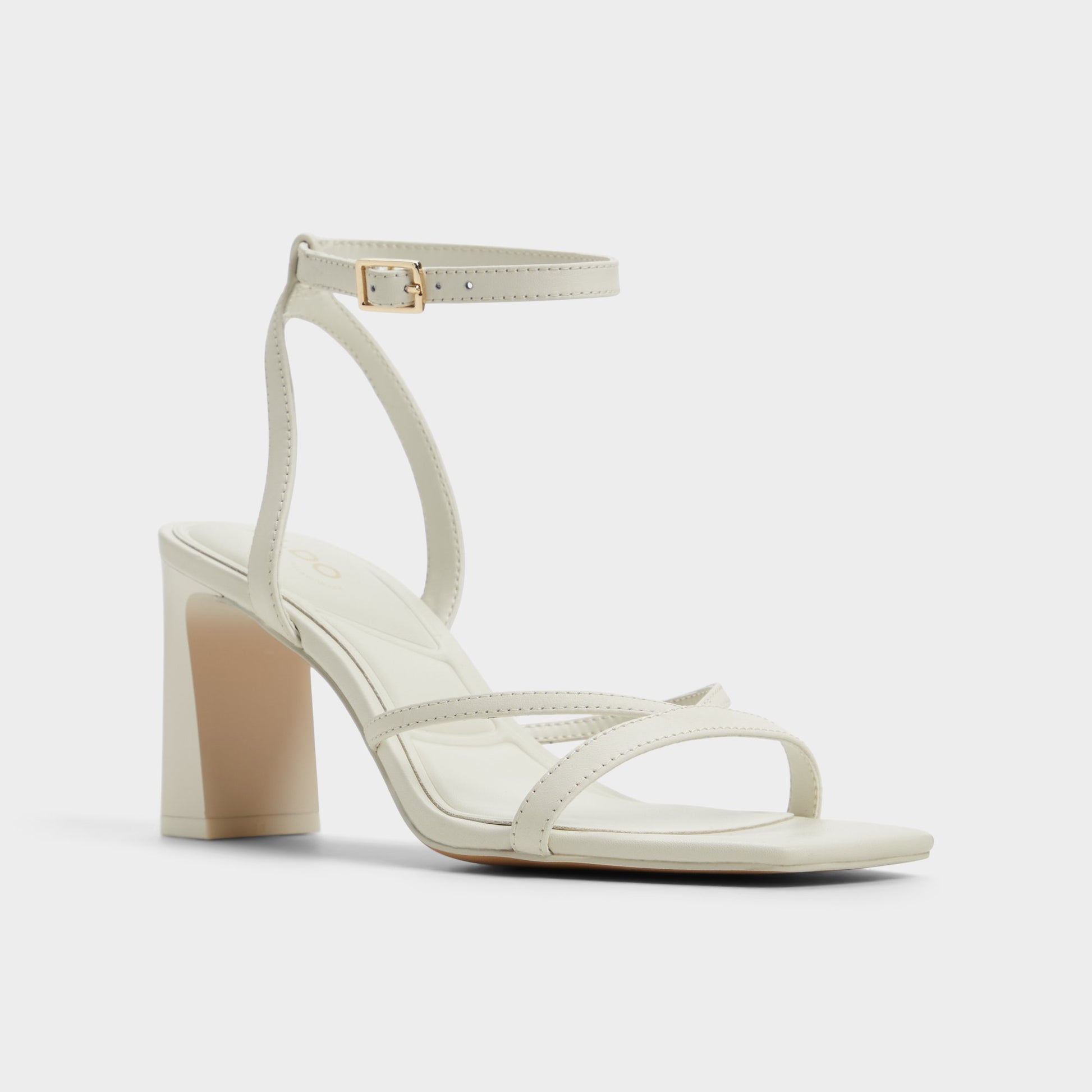 Three-quarter angle of White/Bone Stellare Strappy heeled sandal's front side