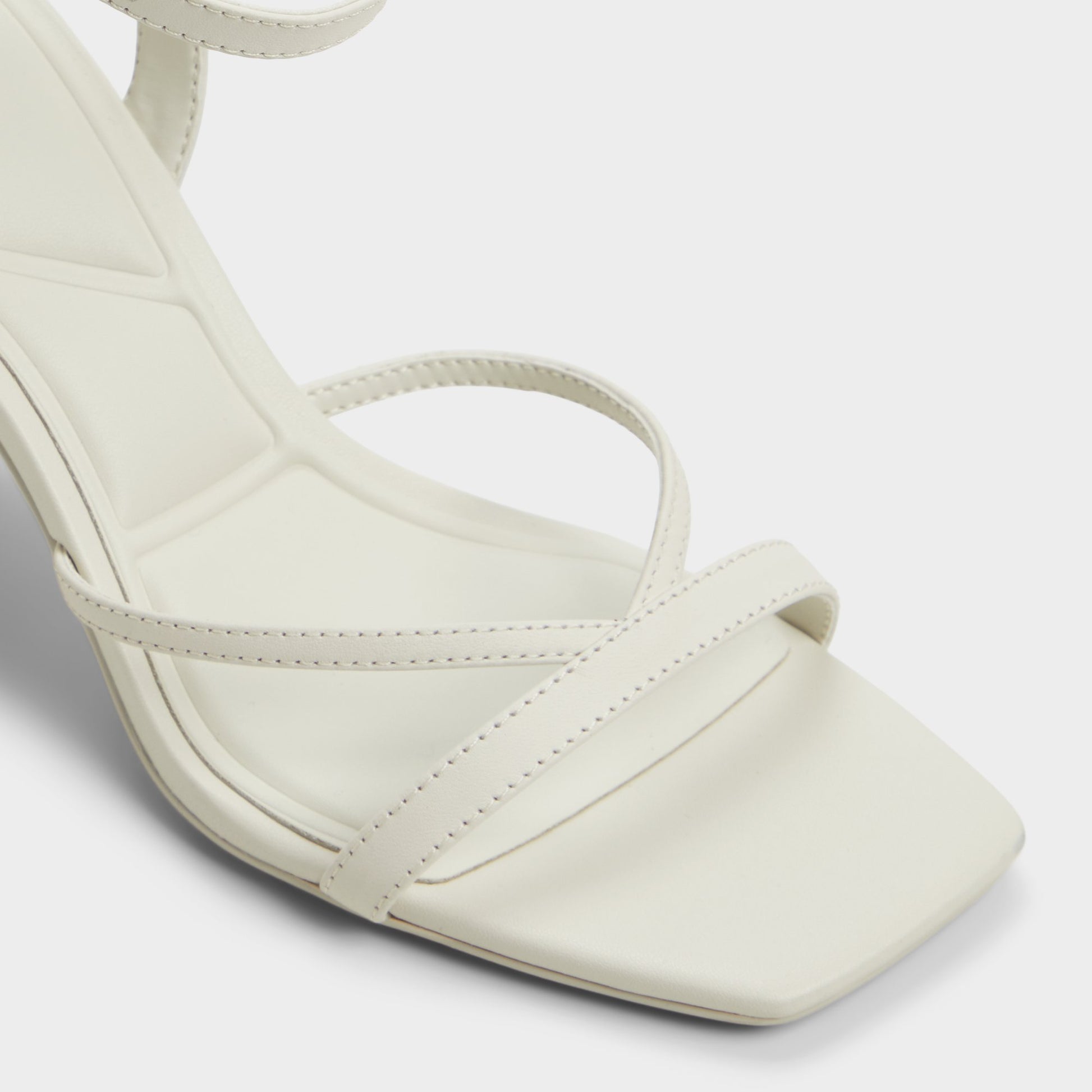 Close-up of the White/Bone Stellare Strappy heeled sandal
