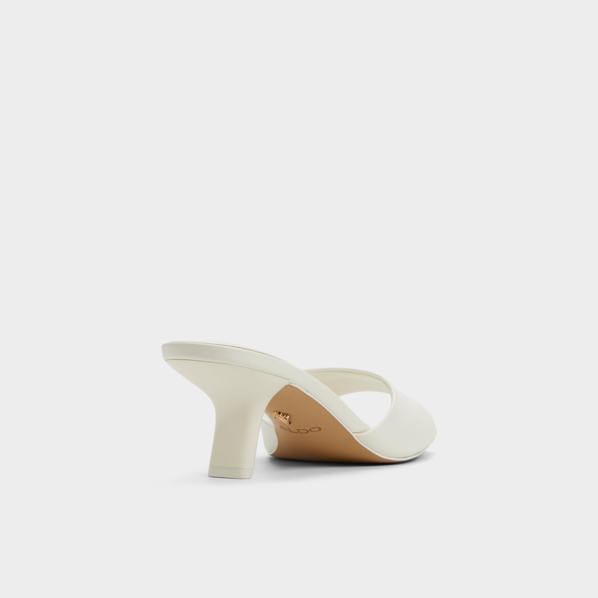 Three-quarter angle of White Enchanting Heeled mule's back side