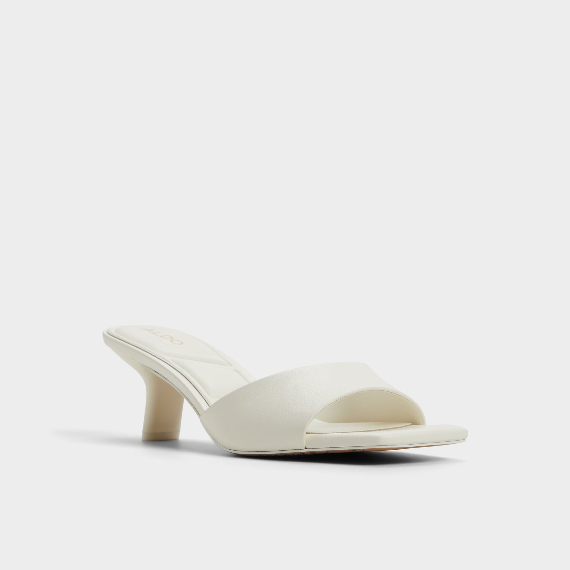 Three-quarter angle of White Enchanting Heeled mule's front side