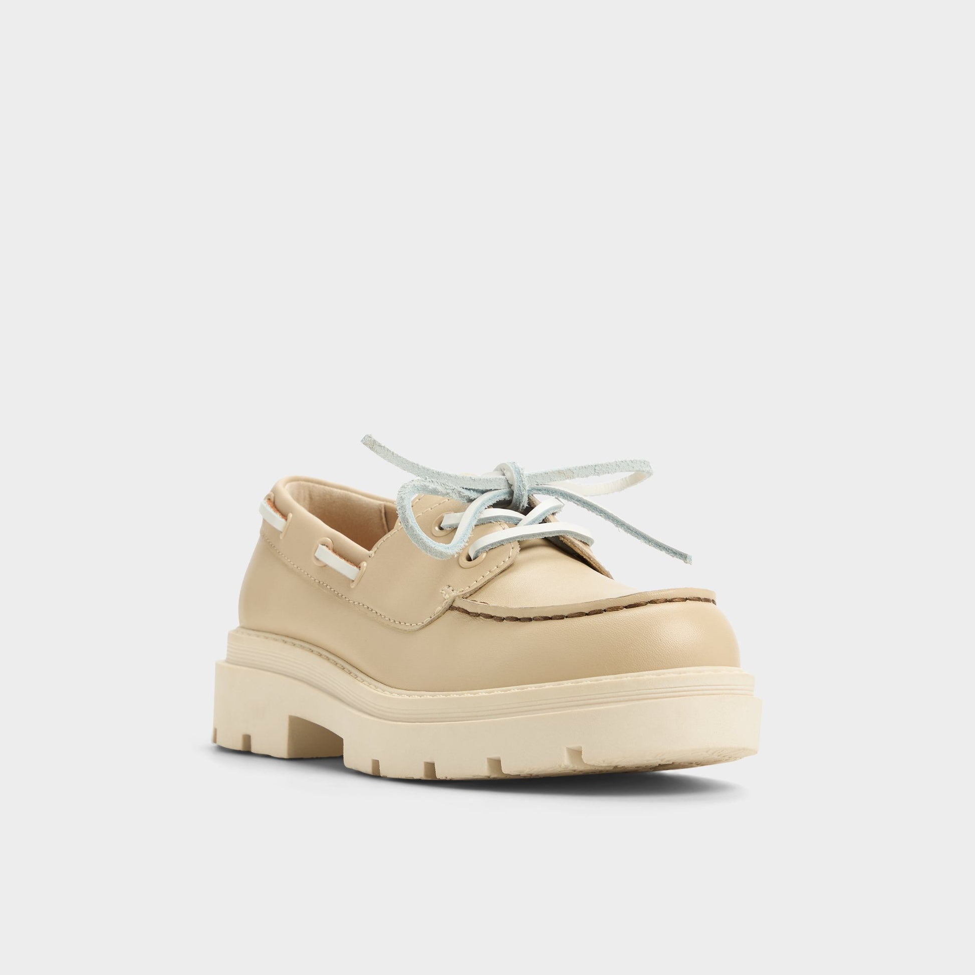 Three-quarter angle of Beige Seaport Boat shoe's front side