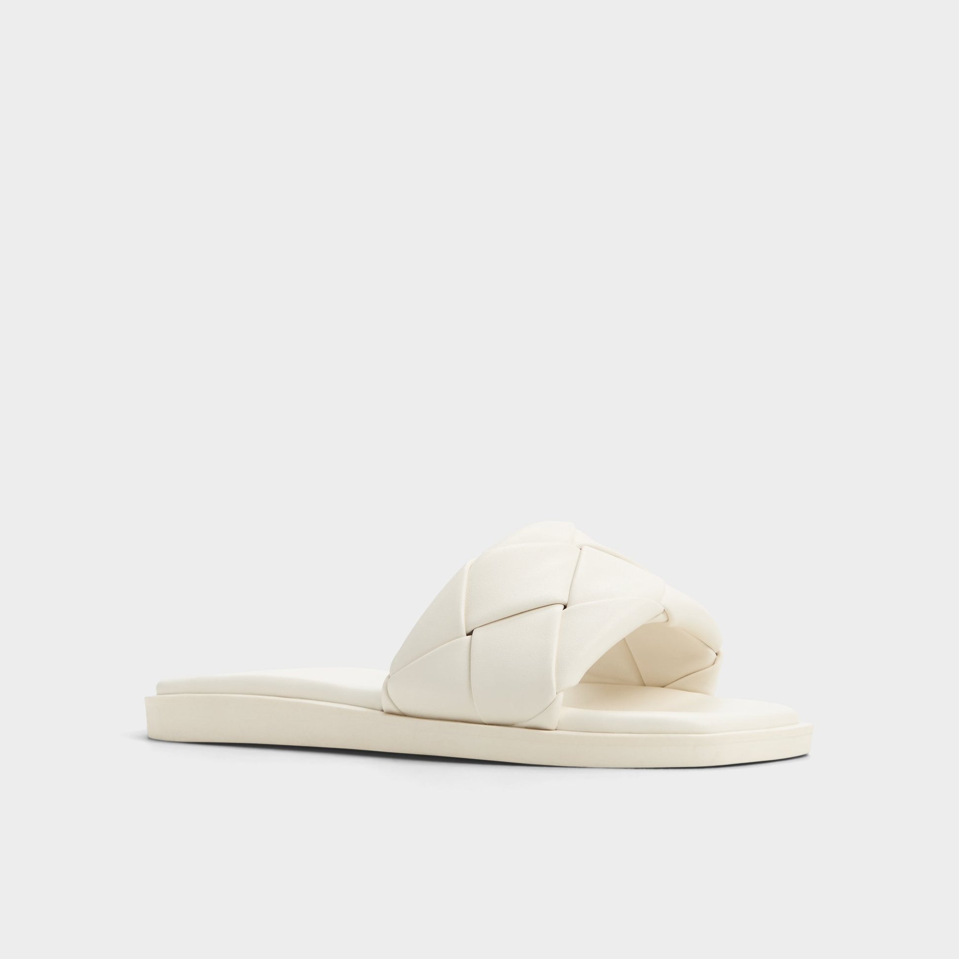 Three-quarter angle of White Esterelle Slide sandal's front side