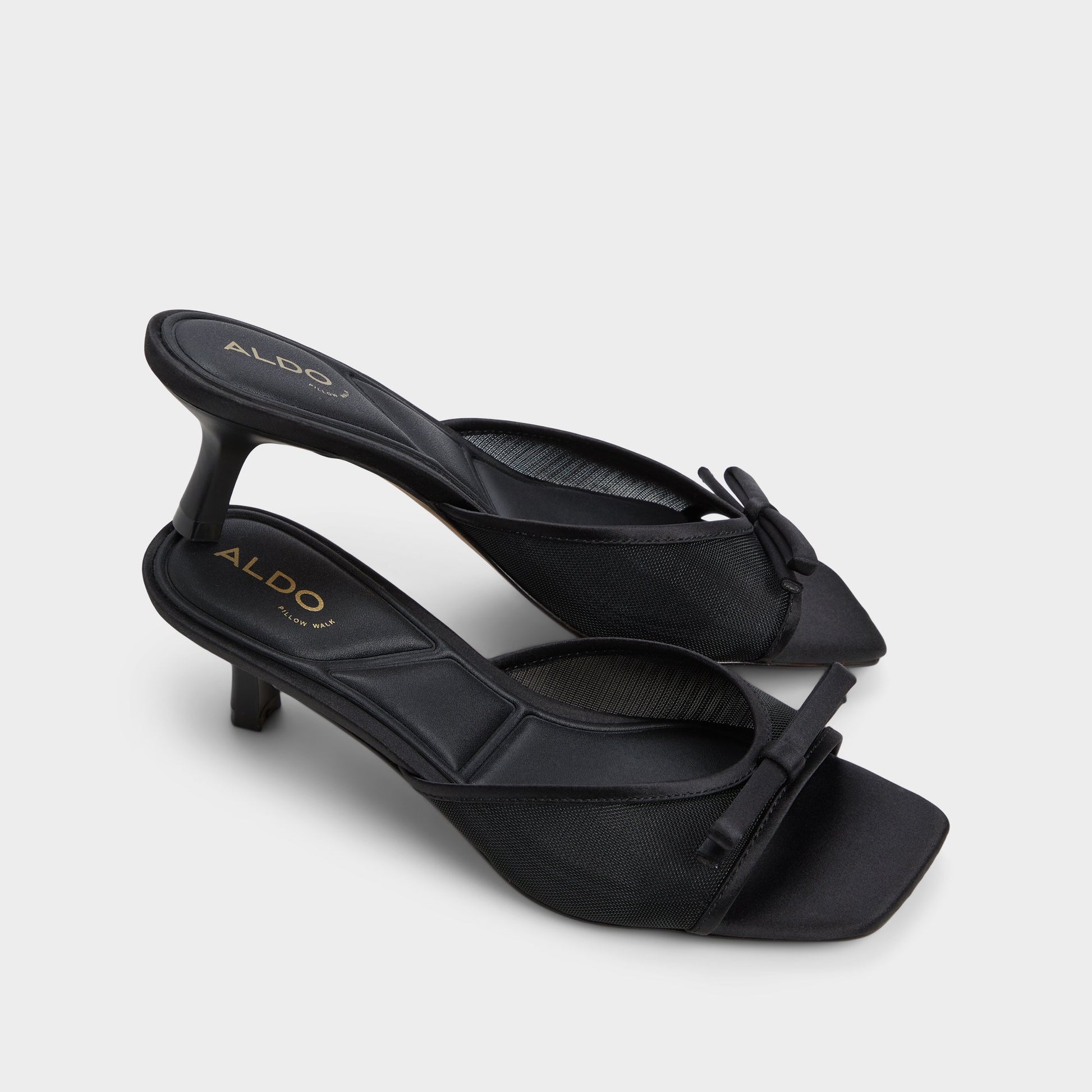 Highlighted view of a pair of Black Begoniaa Heeled mules