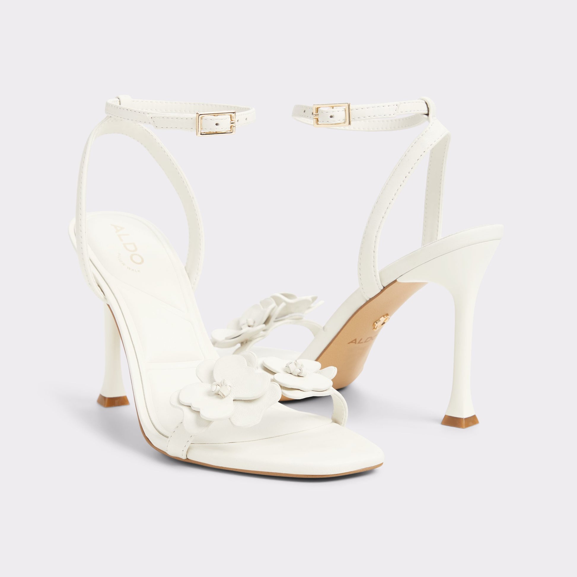 Highlighted view of a pair of White/Bone Daisylily Strappy heeled sandals