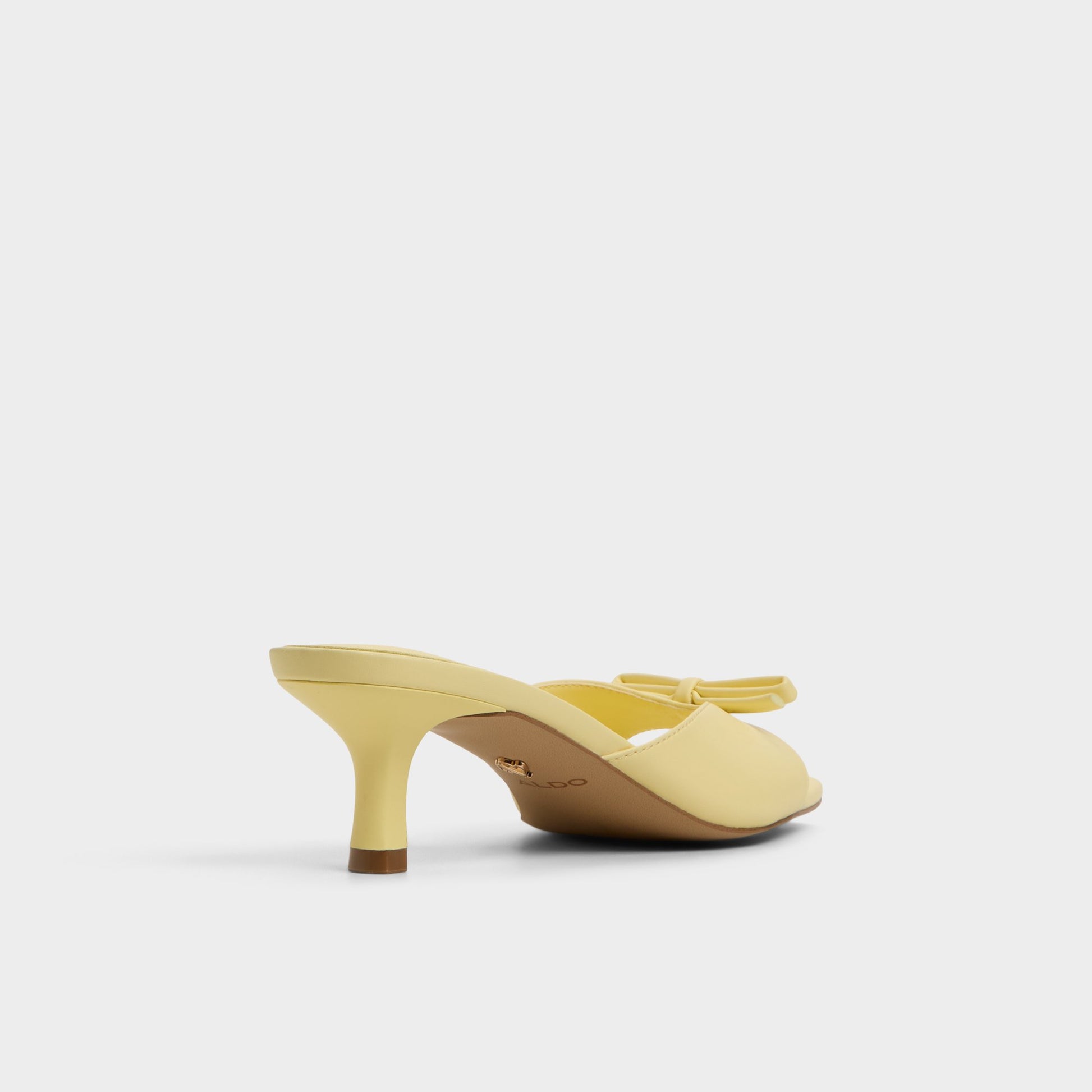 Three-quarter angle of Light Yellow Belerose Heeled mule's back side