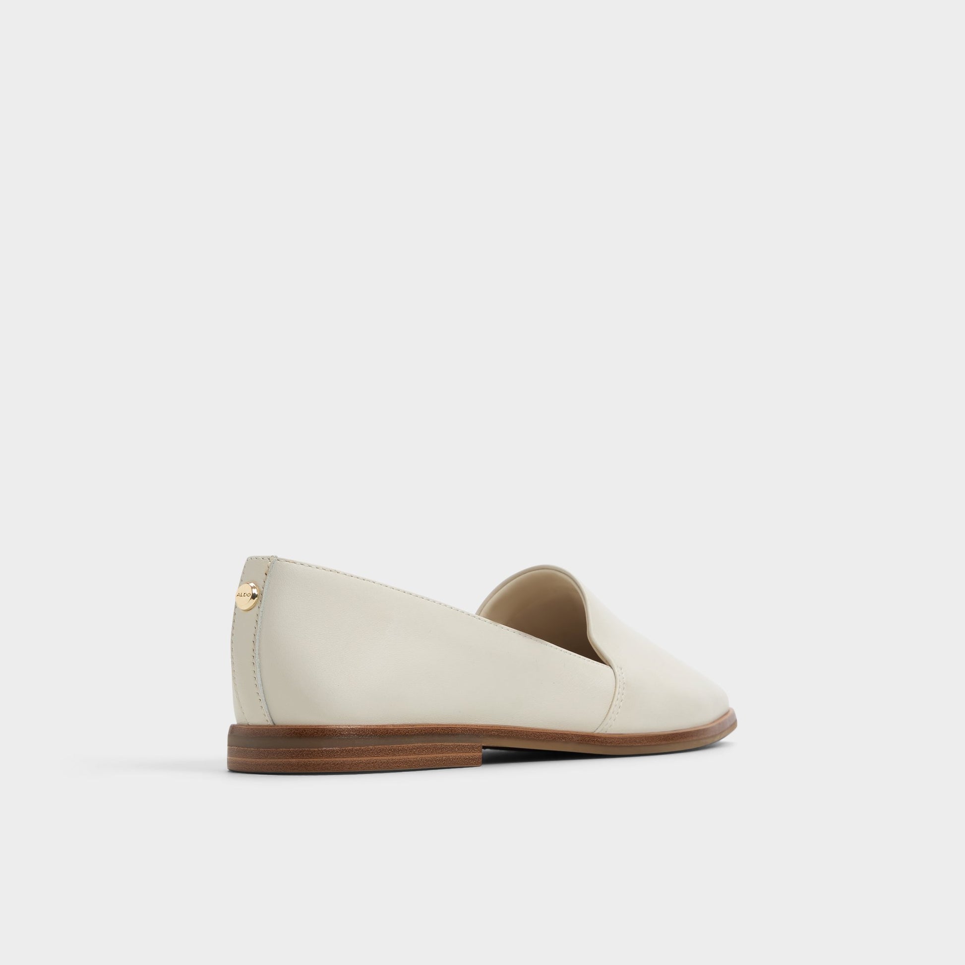 Three-quarter angle of White/Bone Caraelia Slip-on's back side