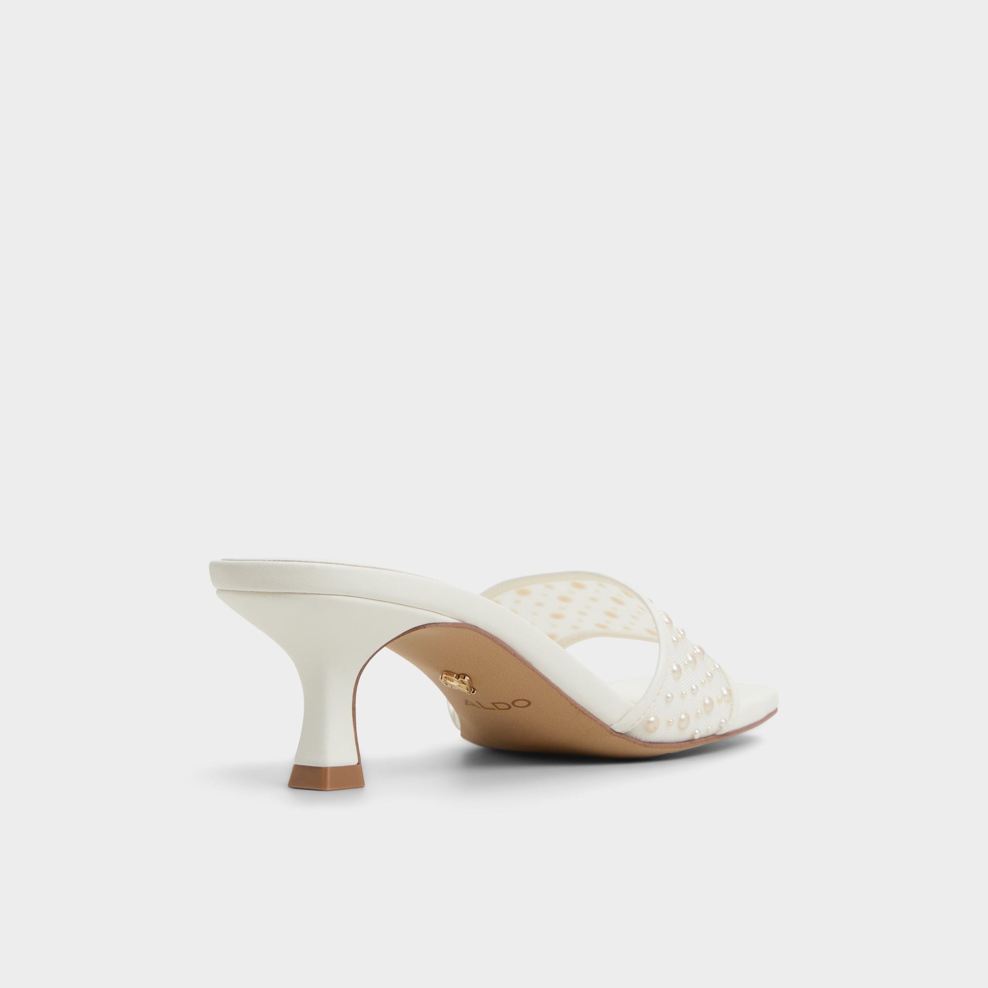 Three-quarter angle of White Pearlia Heeled mule's back side