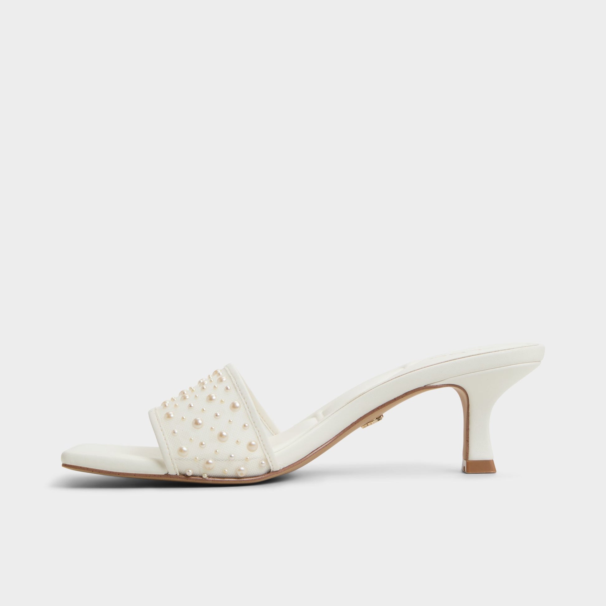 Side view of White Pearlia Heeled mule