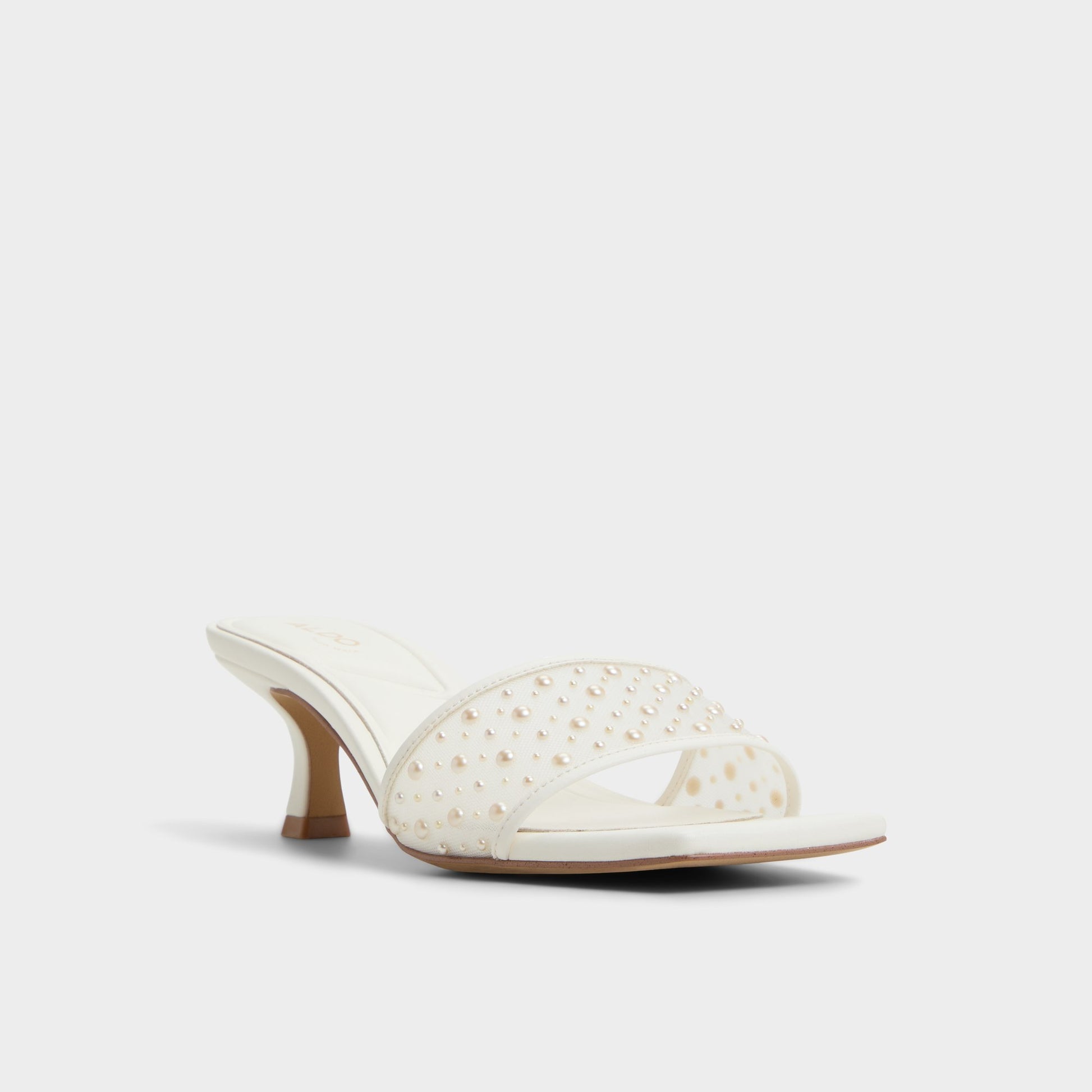 Three-quarter angle of White Pearlia Heeled mule's front side