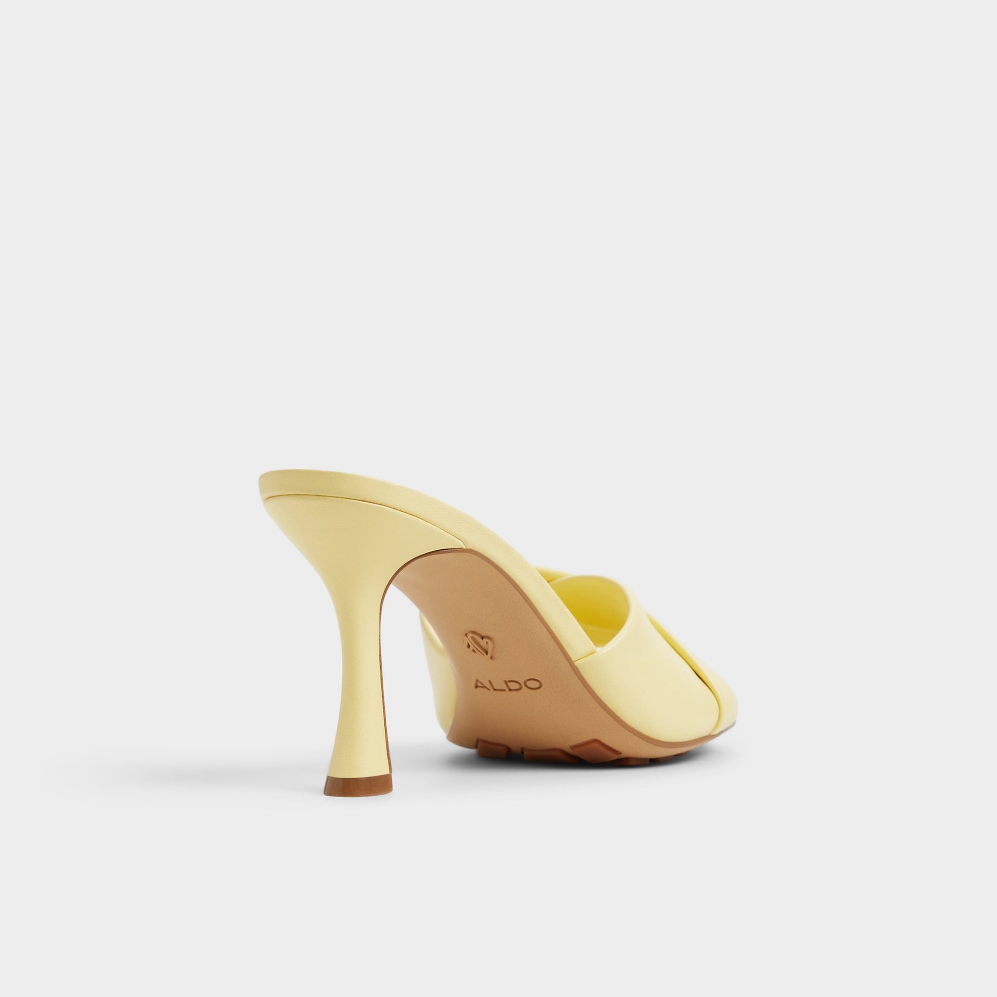 Three-quarter angle of Light Yellow Lyhanna Heeled mule's back side