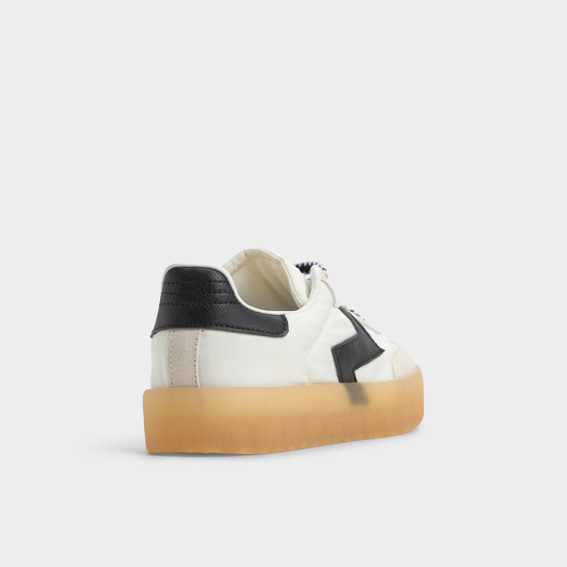 Three-quarter angle of White/Black Retrostep Low top sneaker's back side