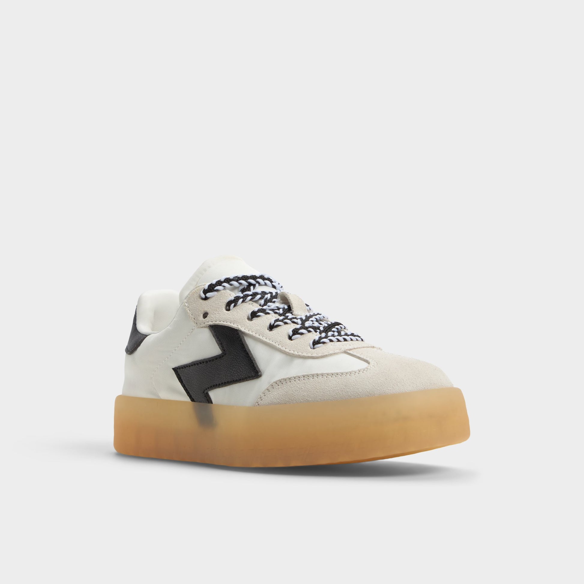 Three-quarter angle of White/Black Retrostep Low top sneaker's front side