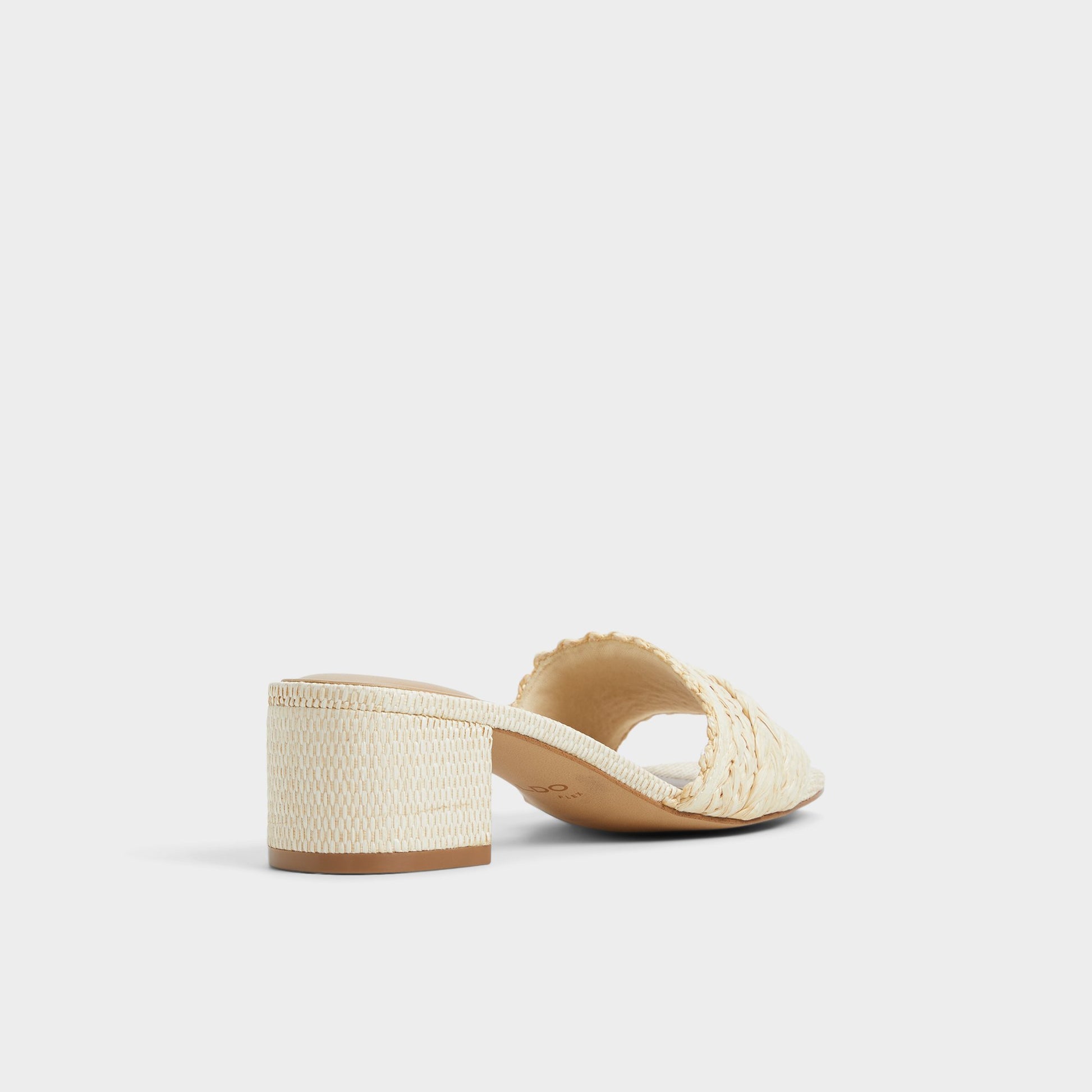 Three-quarter angle of Natural Claudina Heeled mule's back side